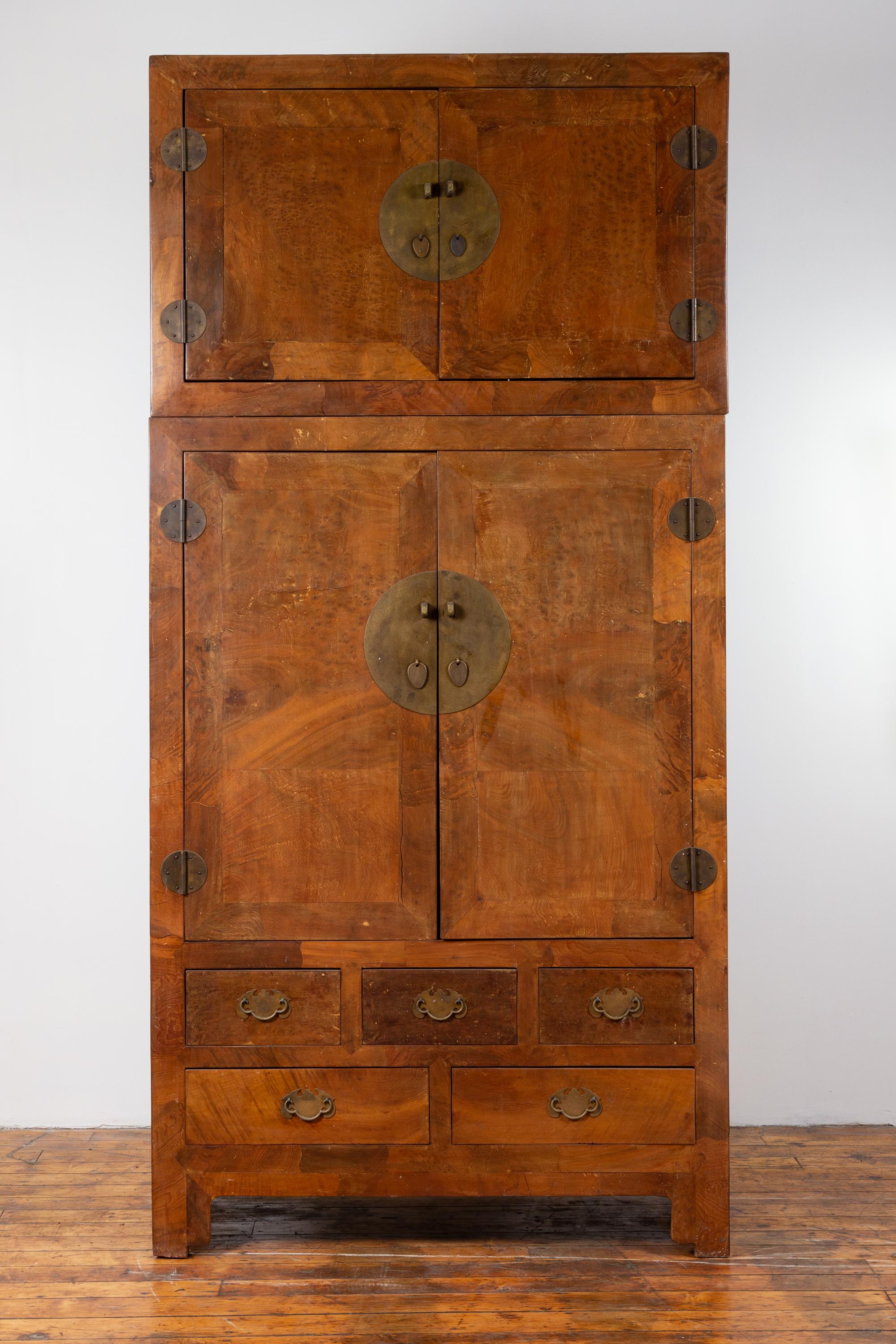 A large vintage elm compound two-part wedding wardrobe, with two sets of double doors, lower drawers and brass hardware. This mid-20th-century large Chinese elm wedding wardrobe beautifully marries traditional design with functional elegance. The