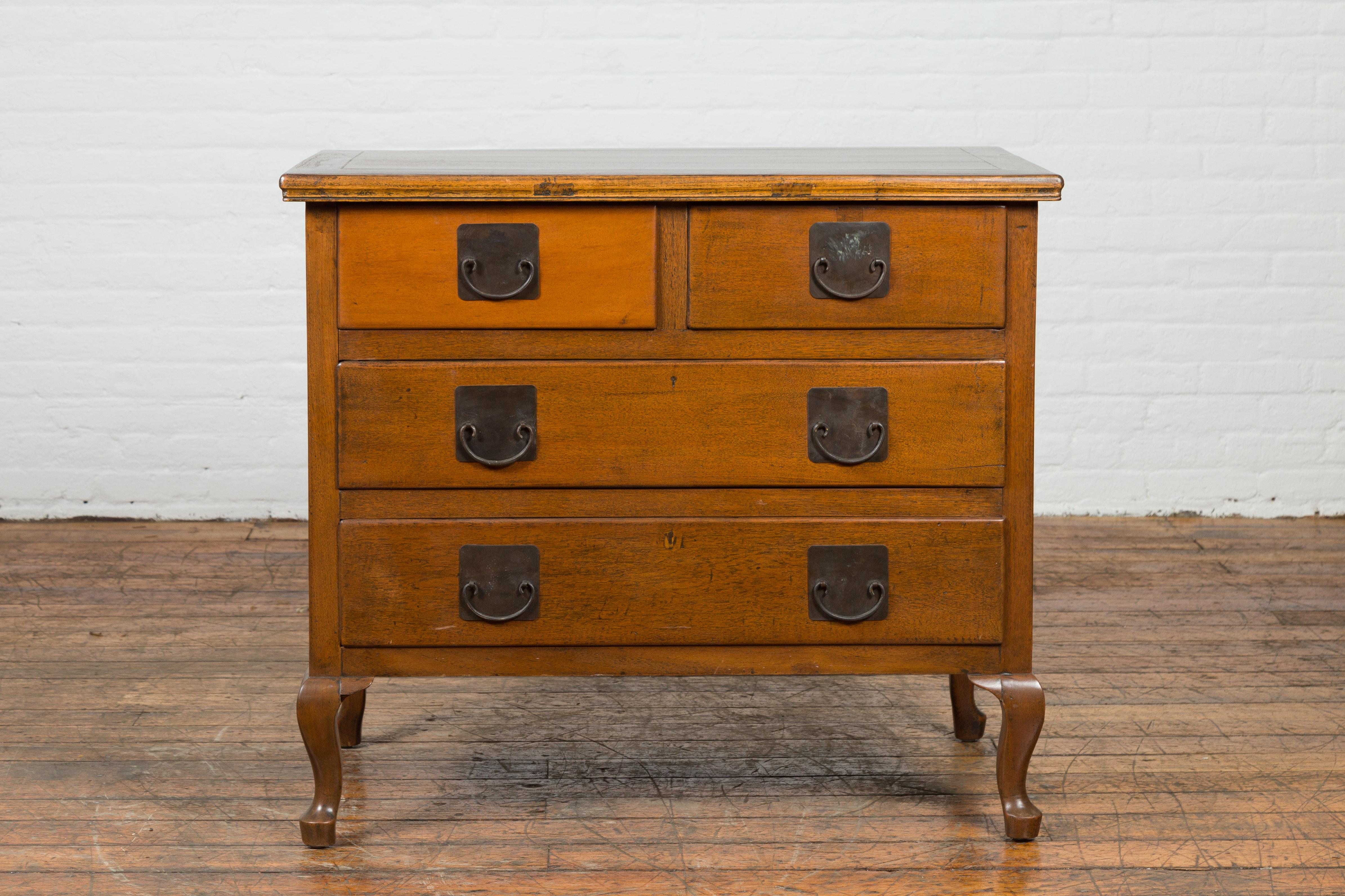 A beautiful Chinese vintage four-drawer dresser chest from the mid 20th century with warm caramel patina and iron hardware. Our vintage chest features a long rectangular top offering ample room for decorating while beneath two square shaped drawers
