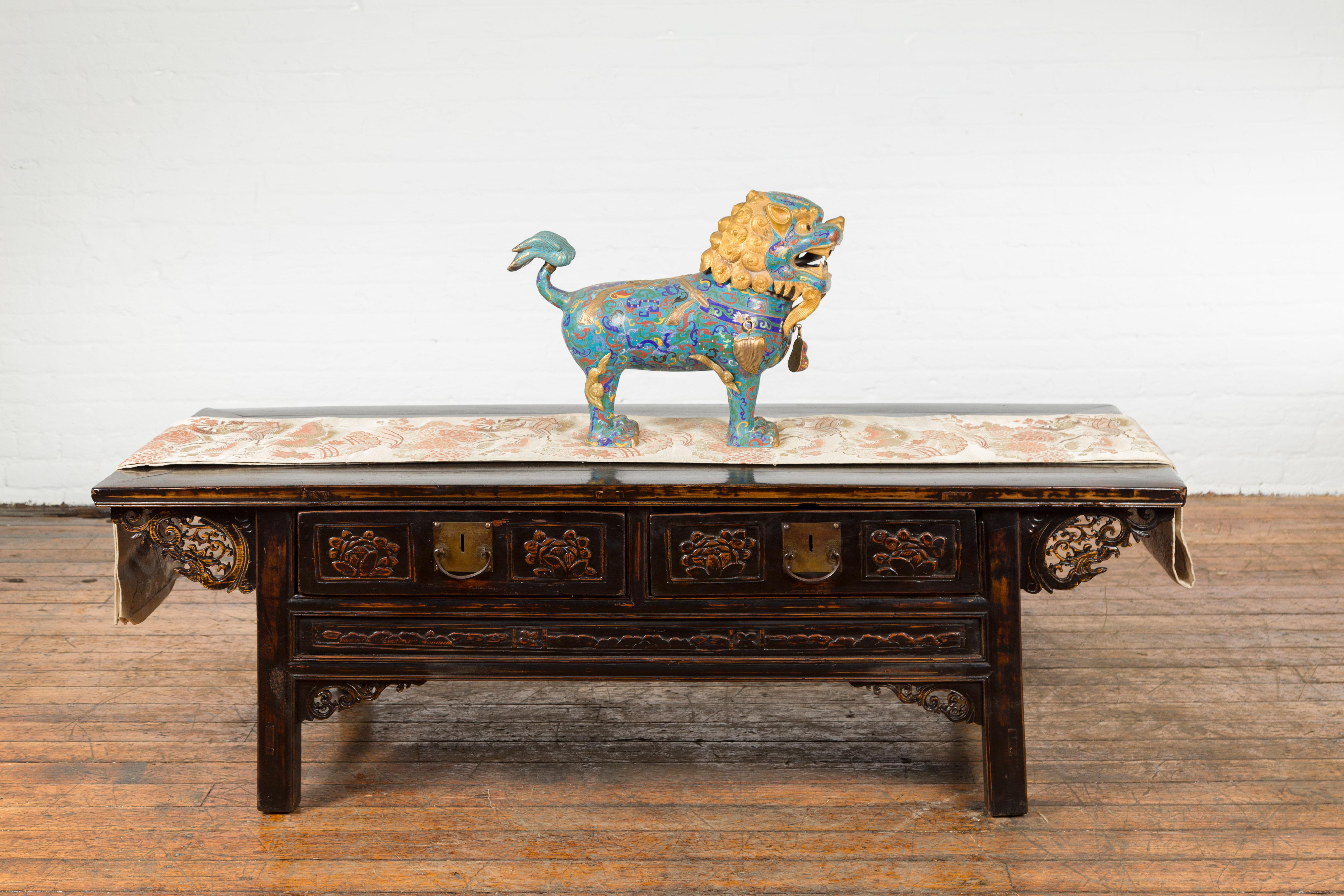 A Chinese vintage metal cloisonné Foo Dog guardian lion sculpture from the mid 20th century. We have a pair available, see item LU863924346552. Photographed together on image 4. Created in China during the midcentury period, this metal cloisonné