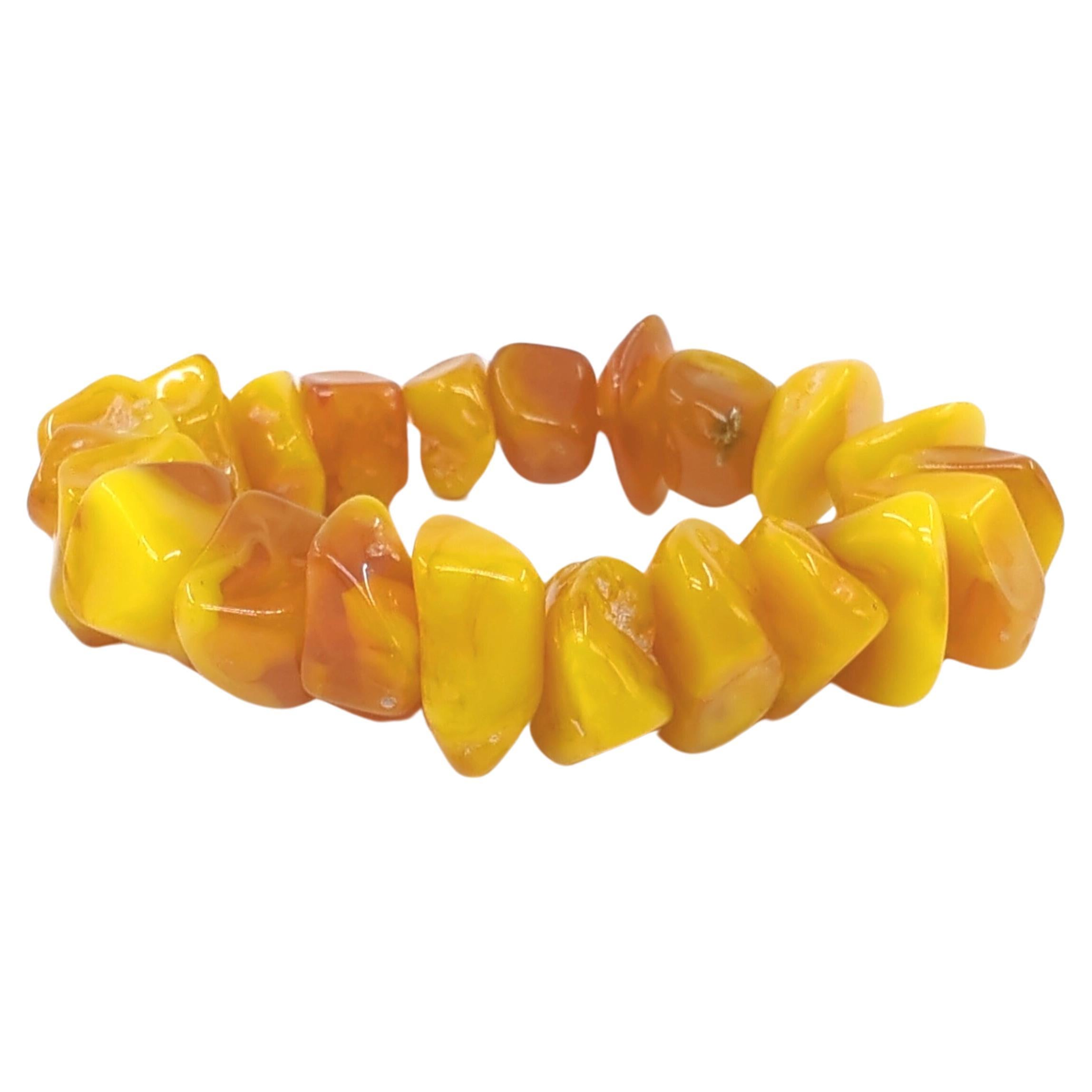 This Chinese beeswax bracelet is a stunning example of natural beauty and craftsmanship. Comprised of 22 individual pieces of natural form beeswax, each piece is carefully polished to reveal its inherent luster. The average dimensions of each