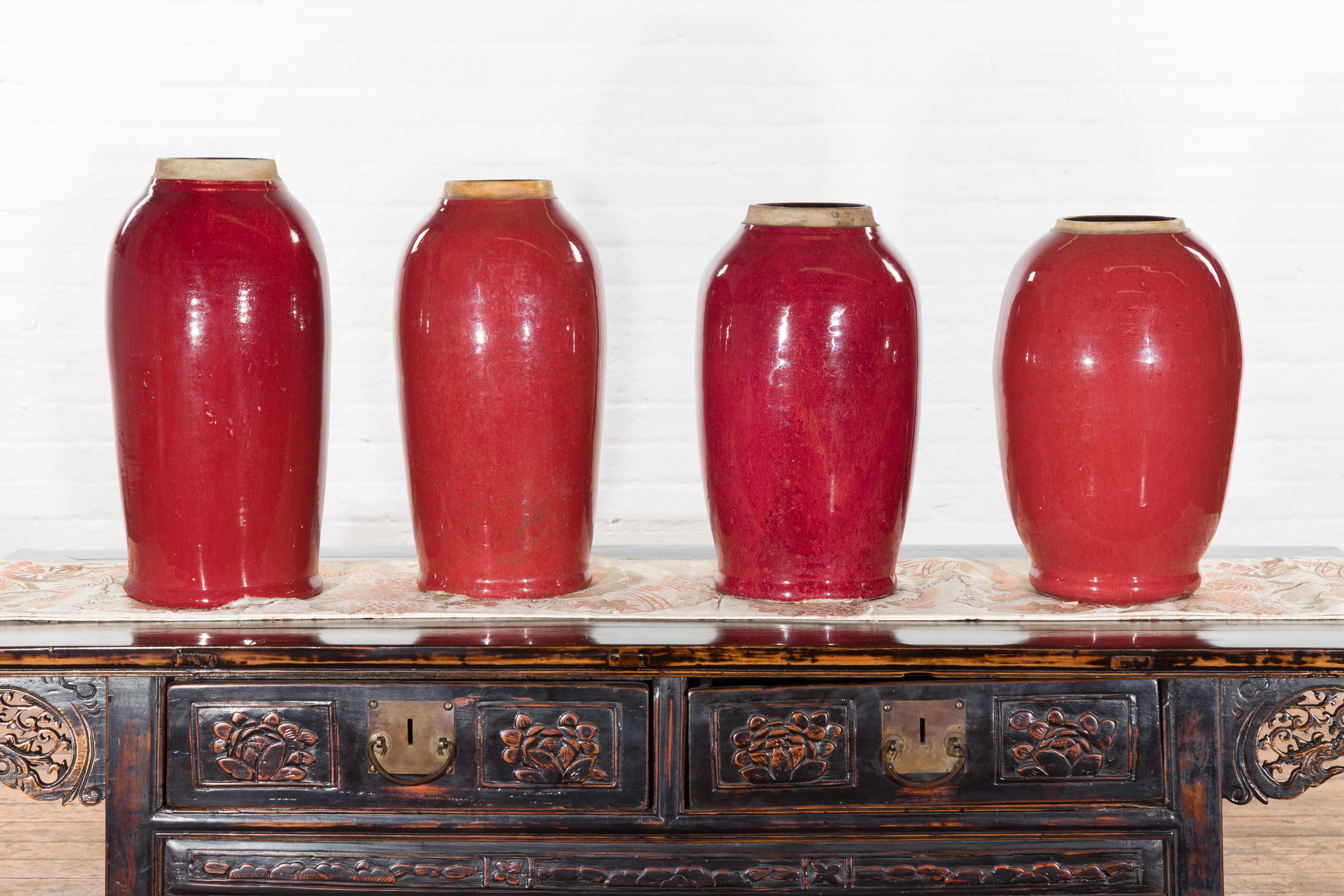 Our vintage oxblood glazed colored altar vases from the mid 20th century make for striking additions to our vast collection of antique and vintage vases. All four vintage vases are from China and crafted with unglazed rimmed openings so that the