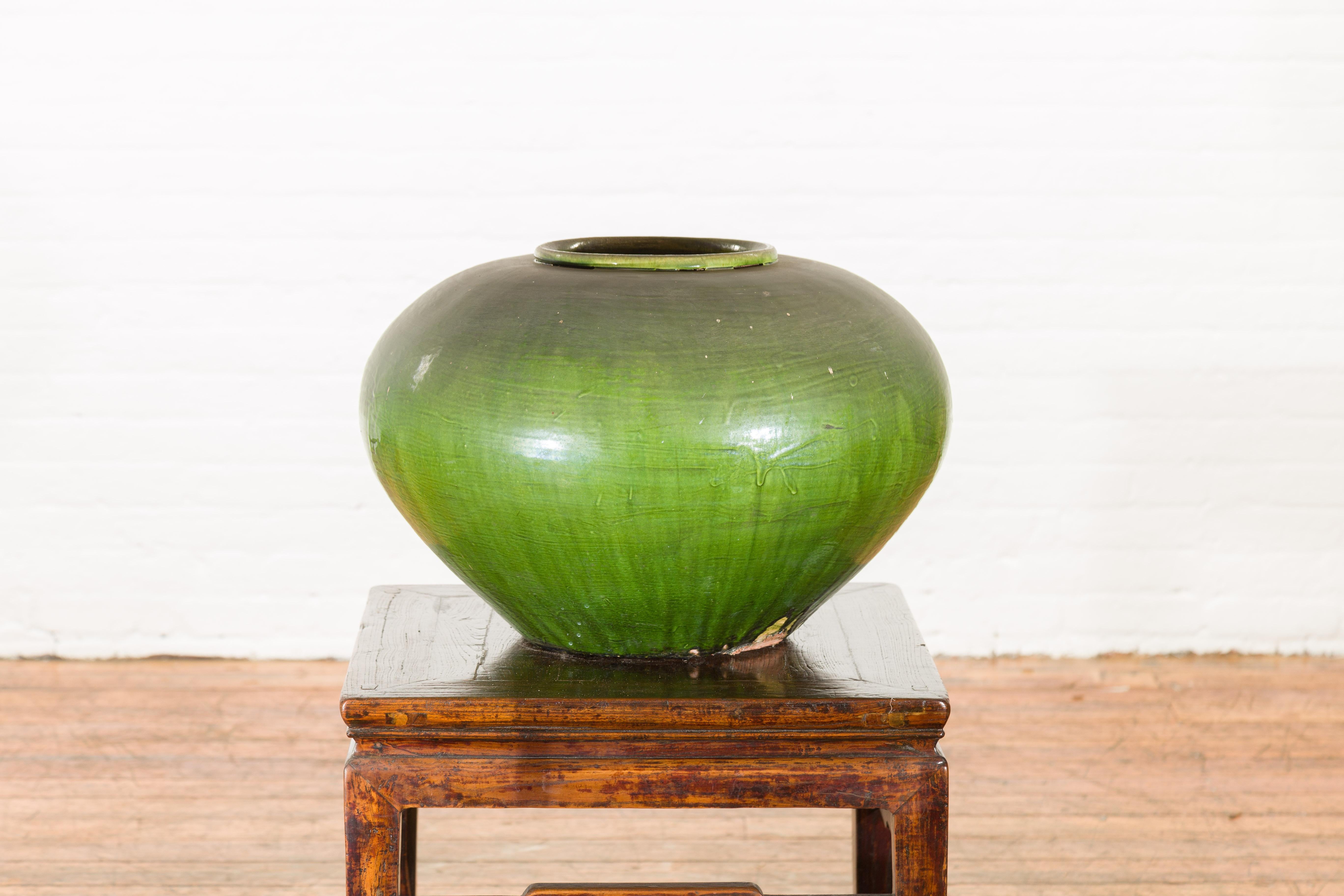 A Chinese vintage porcelain low squat planter from the mid 20th century, with verde glaze. Created in China during the midcentury period, this low squat planter charms us with its generous body and verde glaze. Showcasing a 7.25