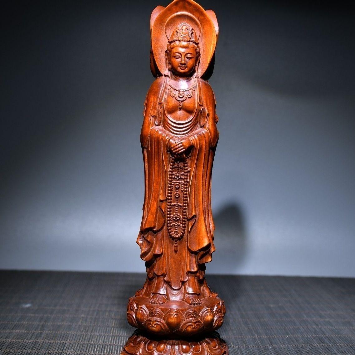 This Chinese Vintage Wood Carving Three Sided Guan Yin Buddhas Statue is very well preserved. Three sided Guanyin refers to a statue of Guanyin with three sides. The front Guanyin holds a scripture box, the right Guanyin holds a lotus, and the left