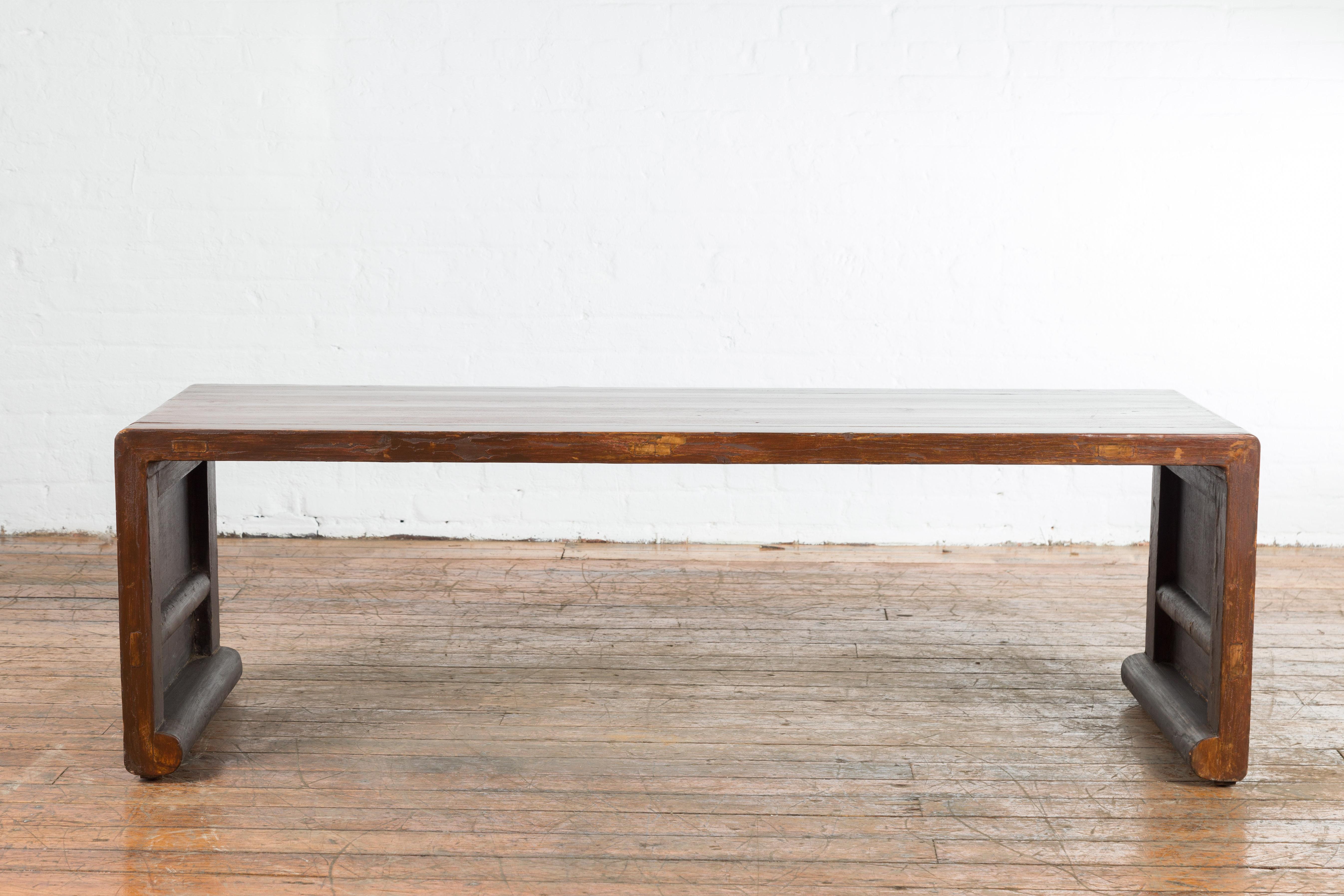 20th Century Chinese Vintage Wooden Waterfall Coffee Table with Distressed Patina and Scrolls For Sale