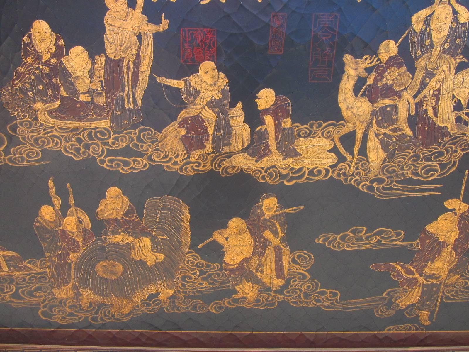 Chinese lacquered wall plaque on wood.