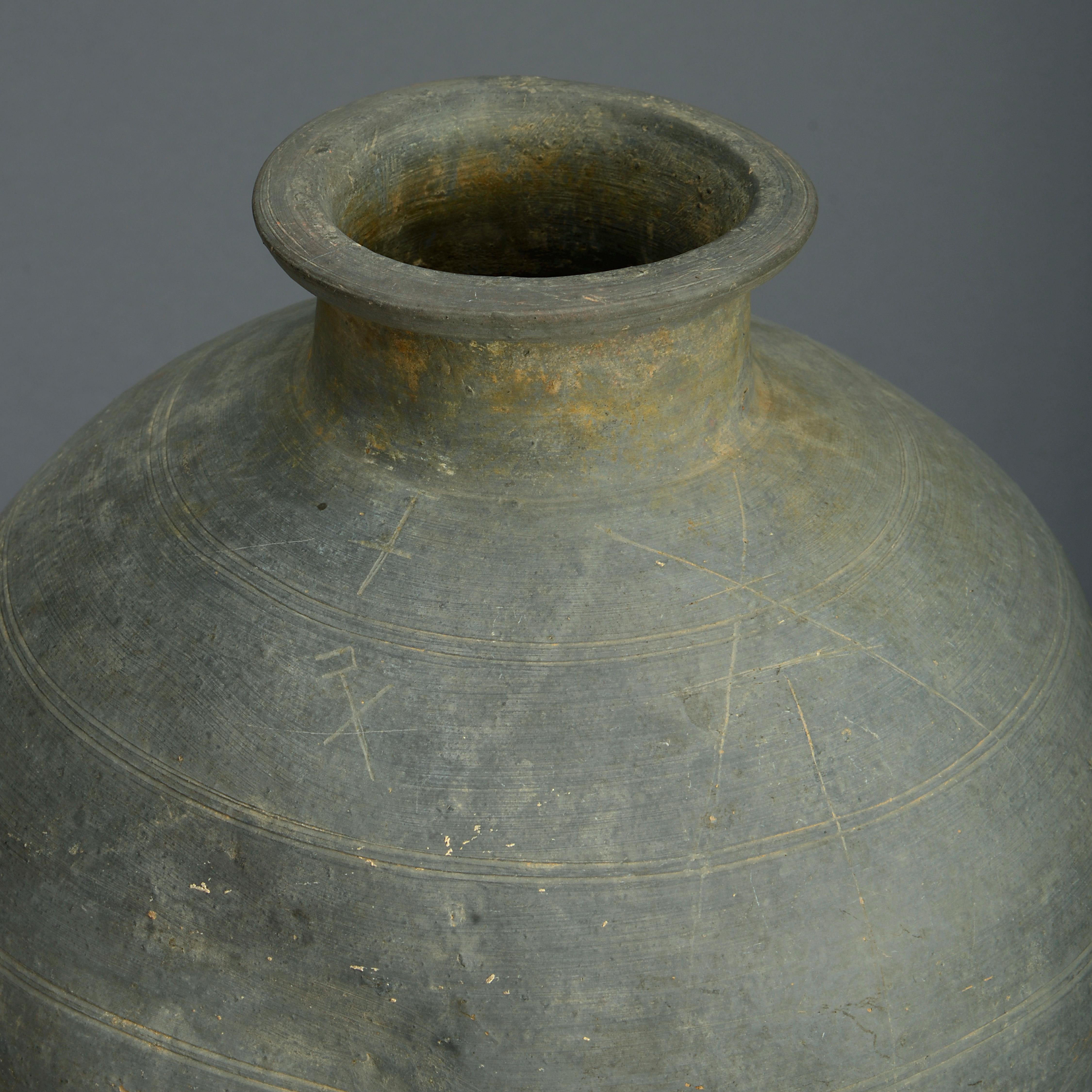 A Chinese warring states or possibly Qin grey pottery jar with incised marks.

This large and generously shaped pottery jar was made during the Warring States Period (475 – 221 BC) or possibly during the Qin Dynasty (221 – 206 BC). It is made from