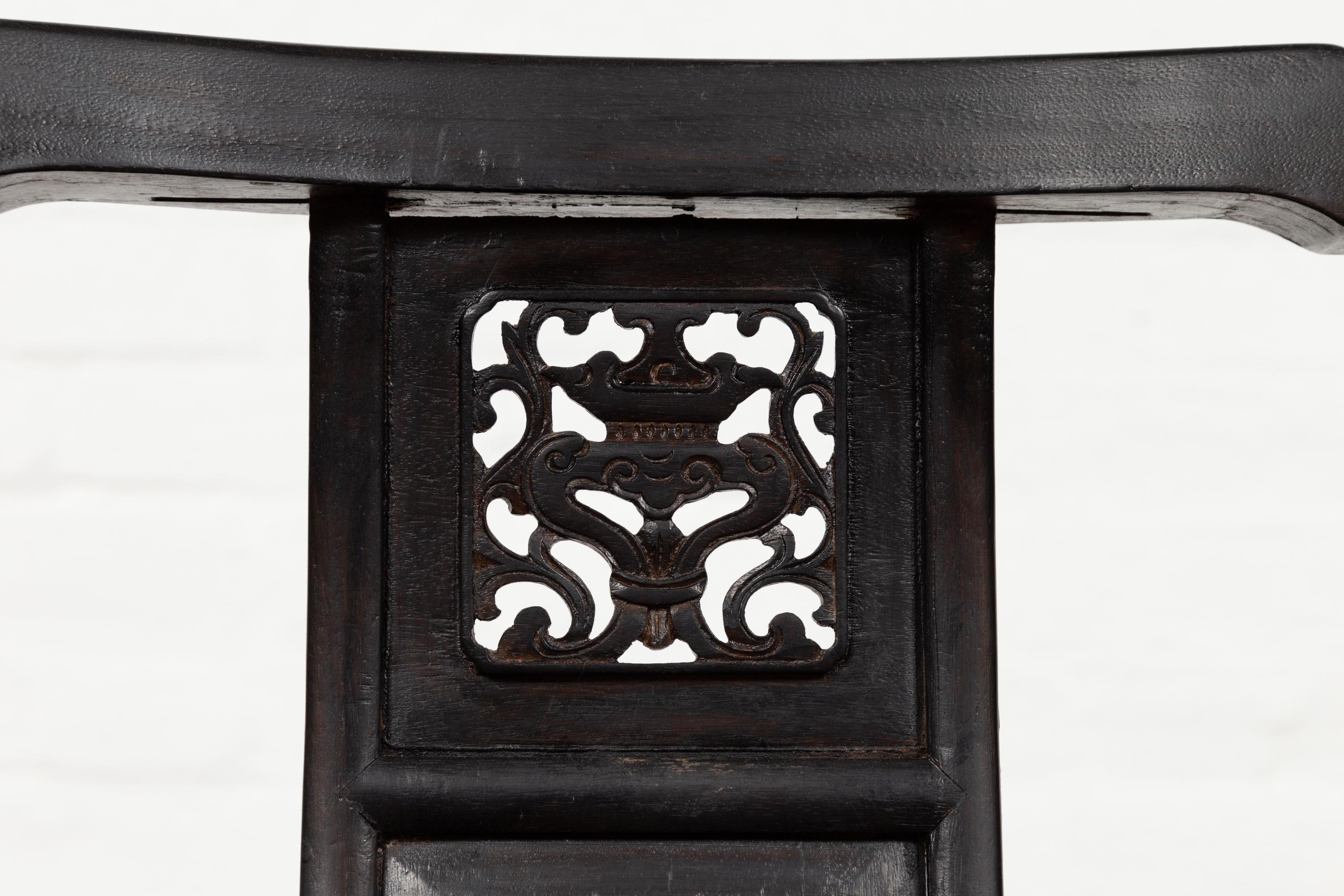 Carved Chinese Wedding Chair with Curvy Pierced Splat, Serpentine Arms and Dark Patina For Sale