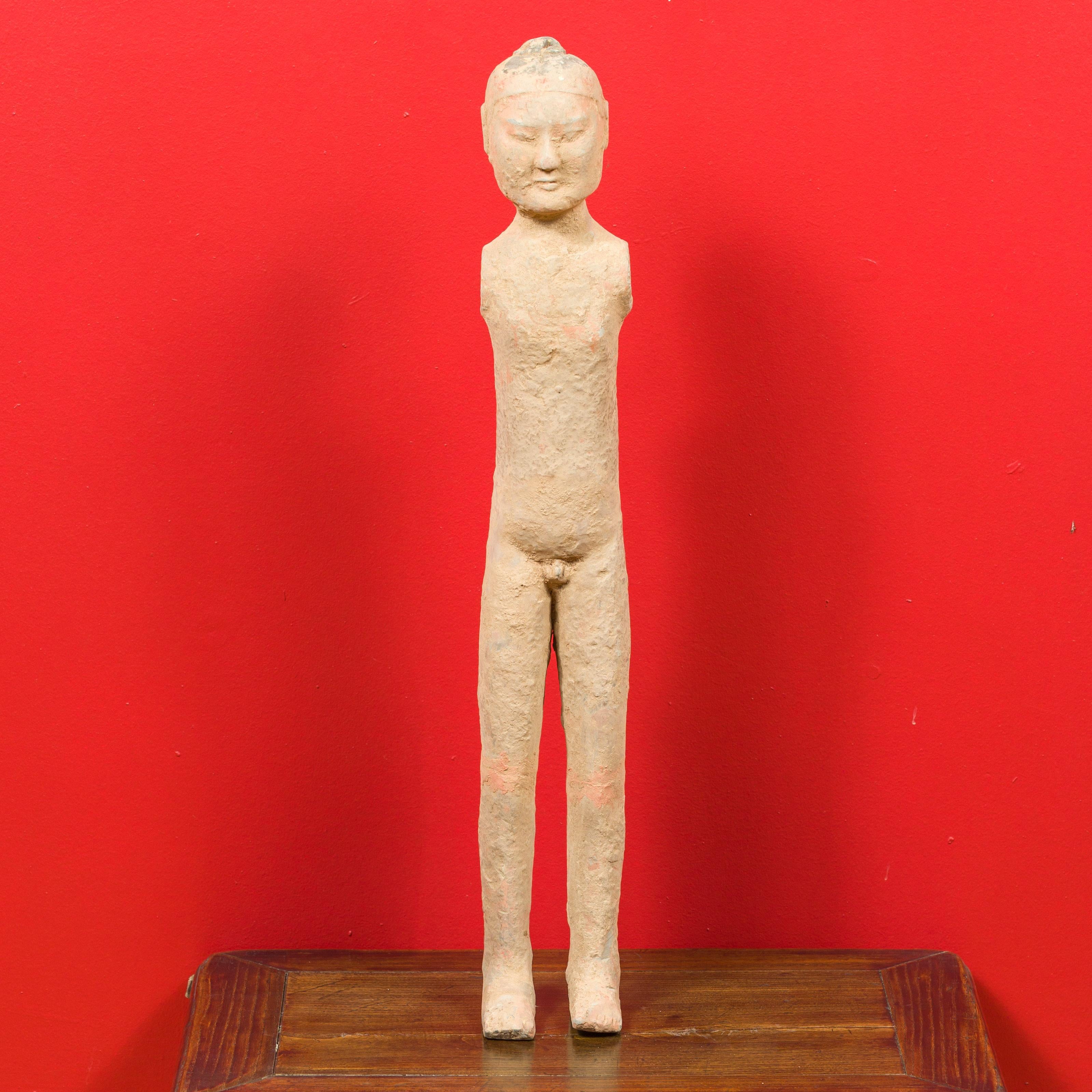 A Chinese Western Han dynasty period armless figurine with original polychromy. Born in China during the Western Han Dynasty (206 BC-24 AD), this naked and armless figurine features a polished surface showing its original polychrome. These figurines