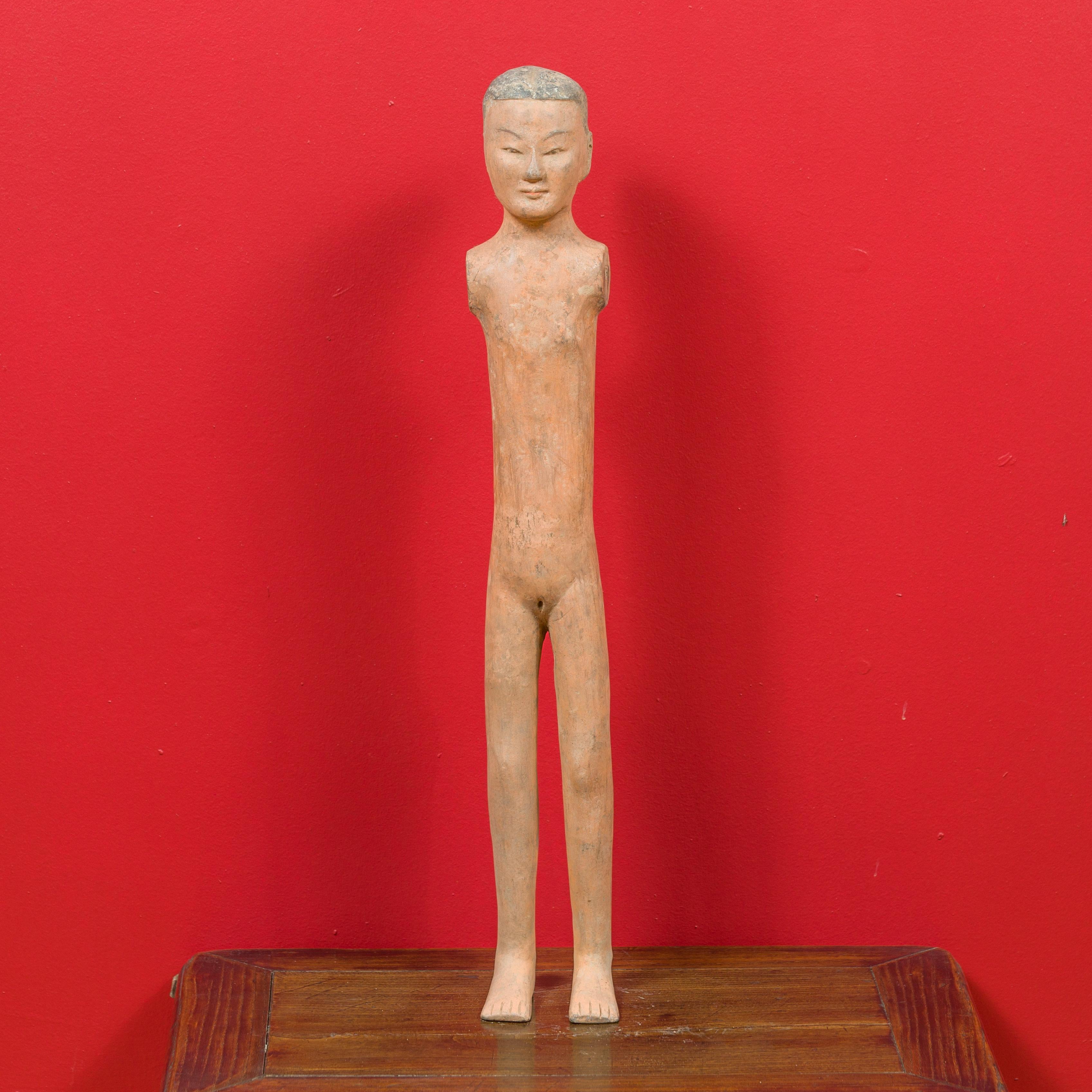 A Chinese Western Han dynasty period armless figurine with original polychromy. Born in China during the Western Han Dynasty (206 BC-24 AD), this naked and armless figurine showcases its original polychromy. These figurines (usually men) were found