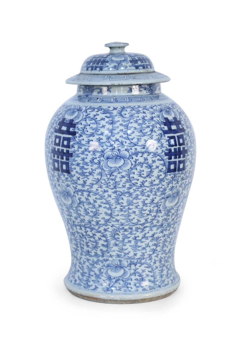 Antique Chinese (late 19th century) lidded ceramic ginger jar urn with blue floral designs surrounding bold, centered characters on 4 sides.
       