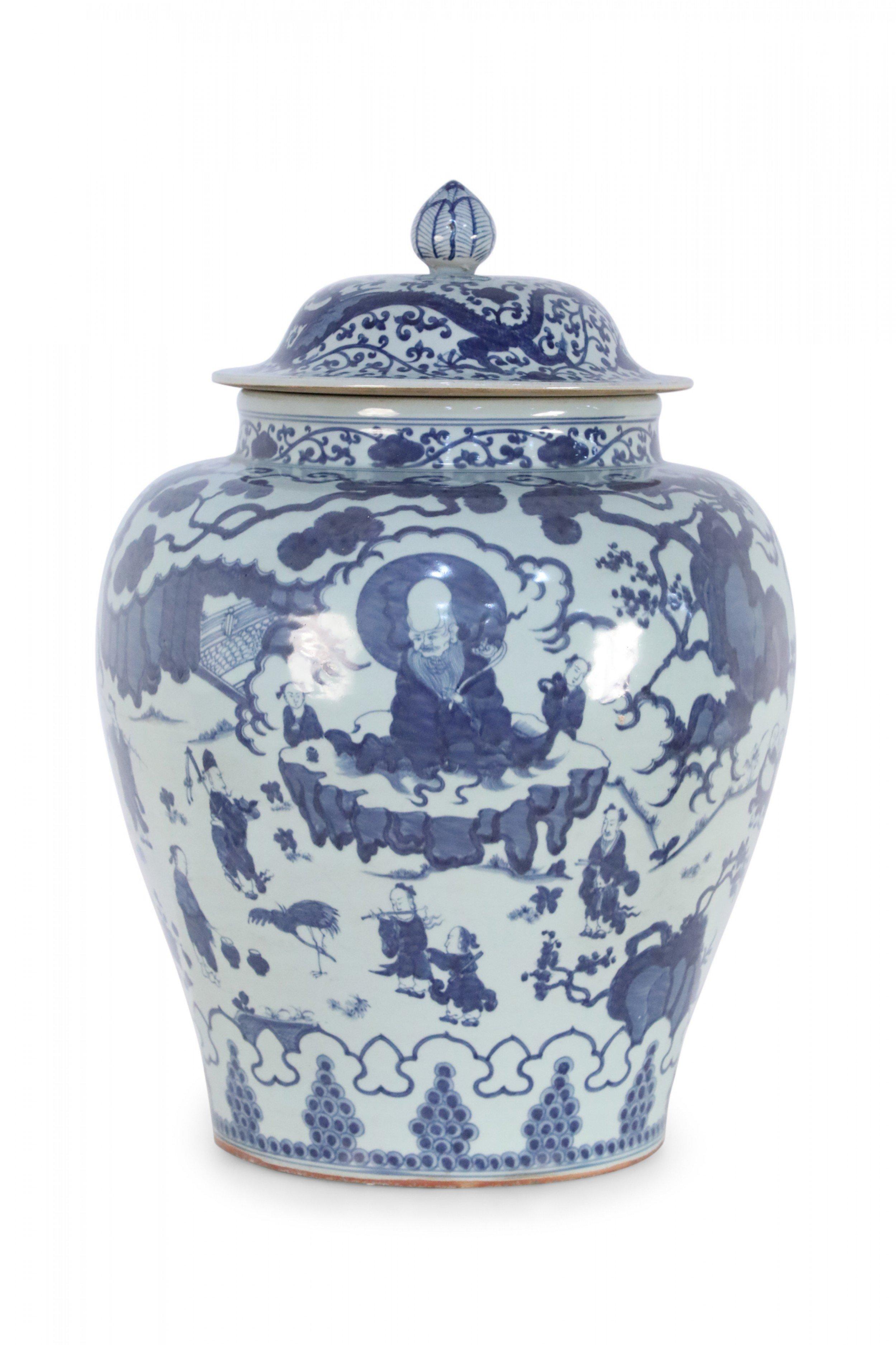 Chinese white porcelain ginger jar decorated with blue figures amid scroll detailing with a finial topped lid.
 