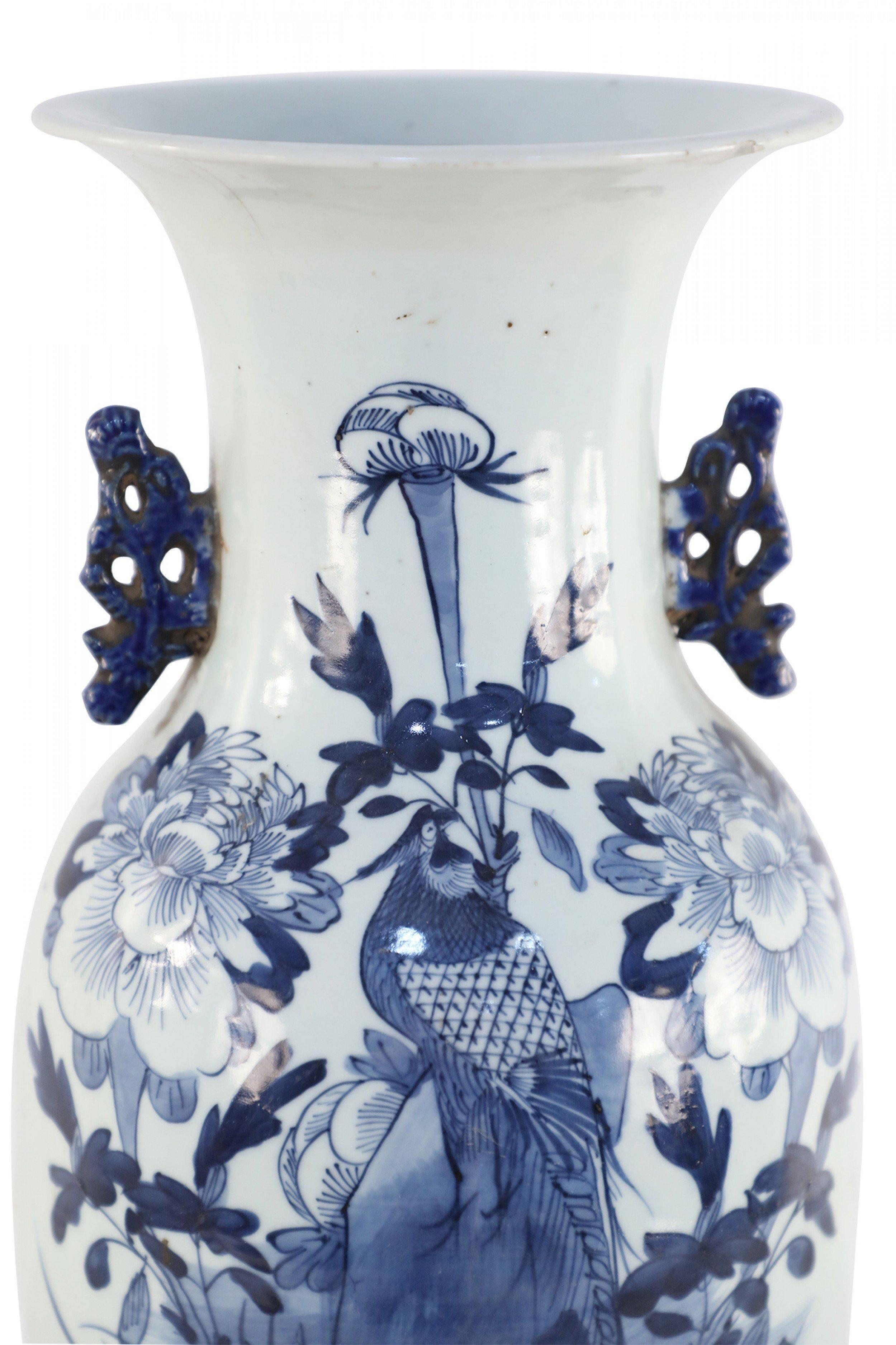 Antique Chinese (Late 19th century) white and blue porcelain urn decorated with a bird amid a flowering garden, and accented in two navy scrolled handles along the neck.
   