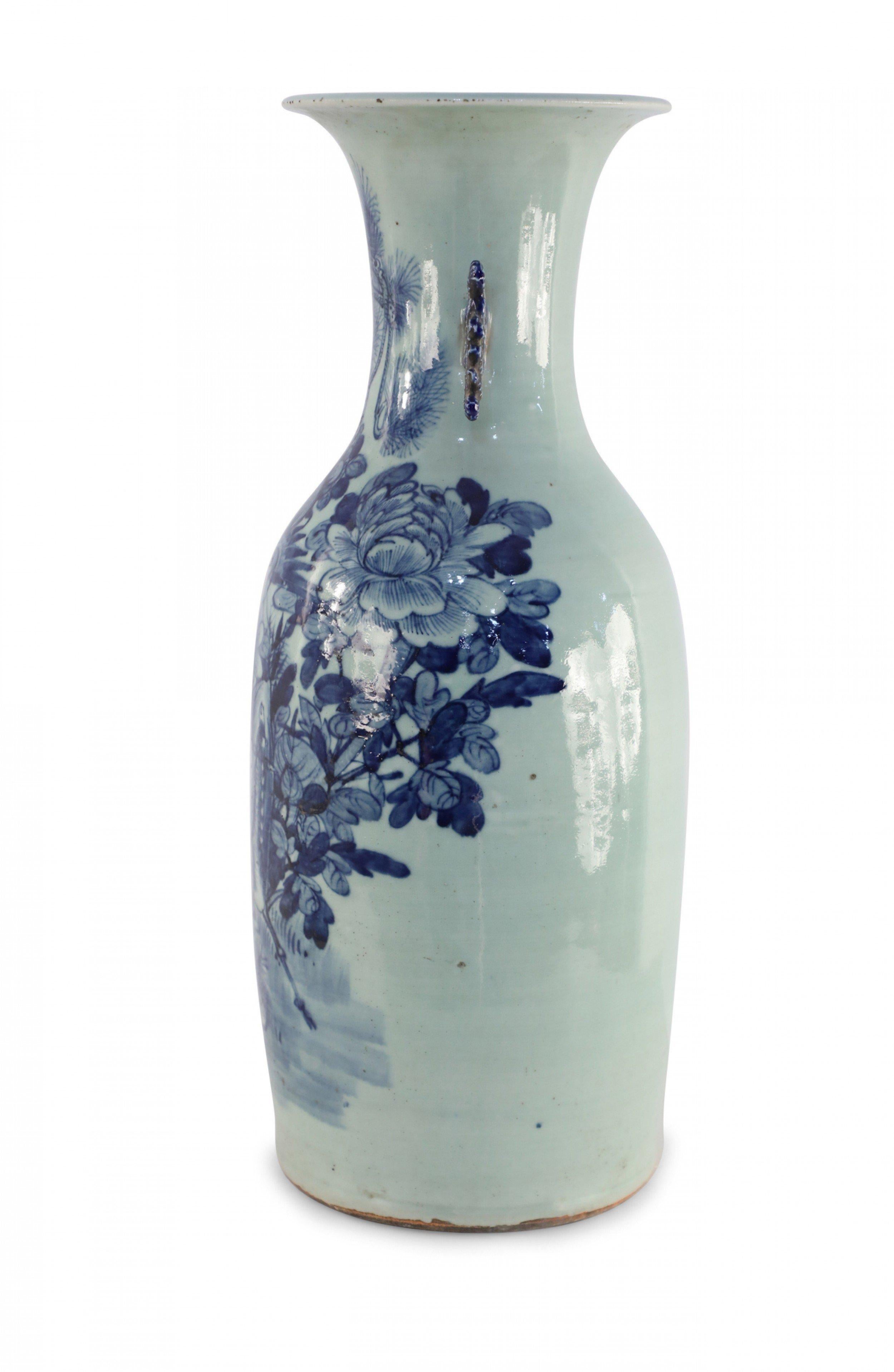 Antique Chinese (late 19th century) large white, porcelain urn with a scene of blue flora and fauna, and two dark blue scrolled handles along the neck.
   