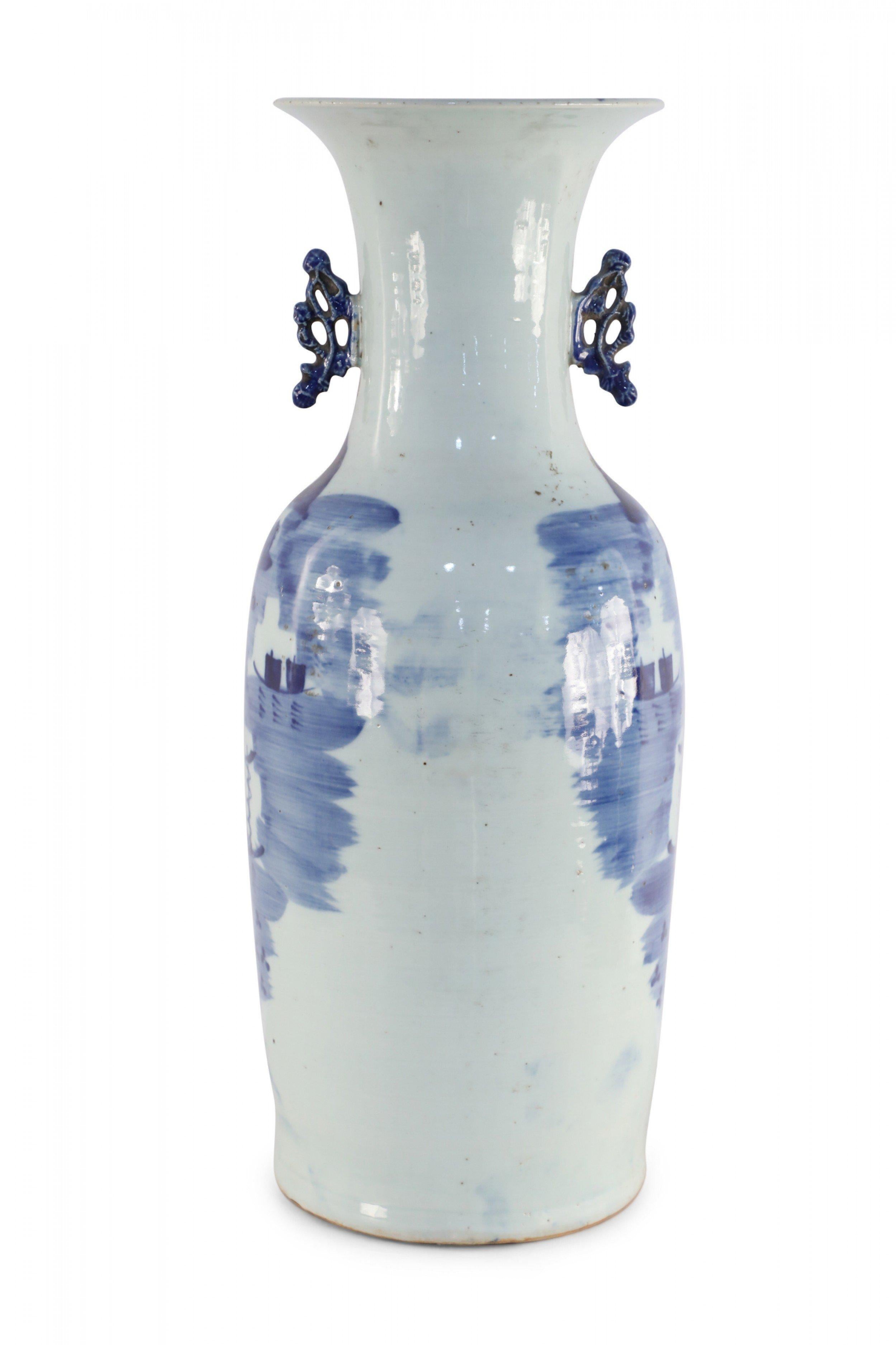 Antique Chinese (late 19th century) large white, porcelain urn depicting a blue scene of a village along the water, and finished with two dark blue scrolled handles along the neck.
     