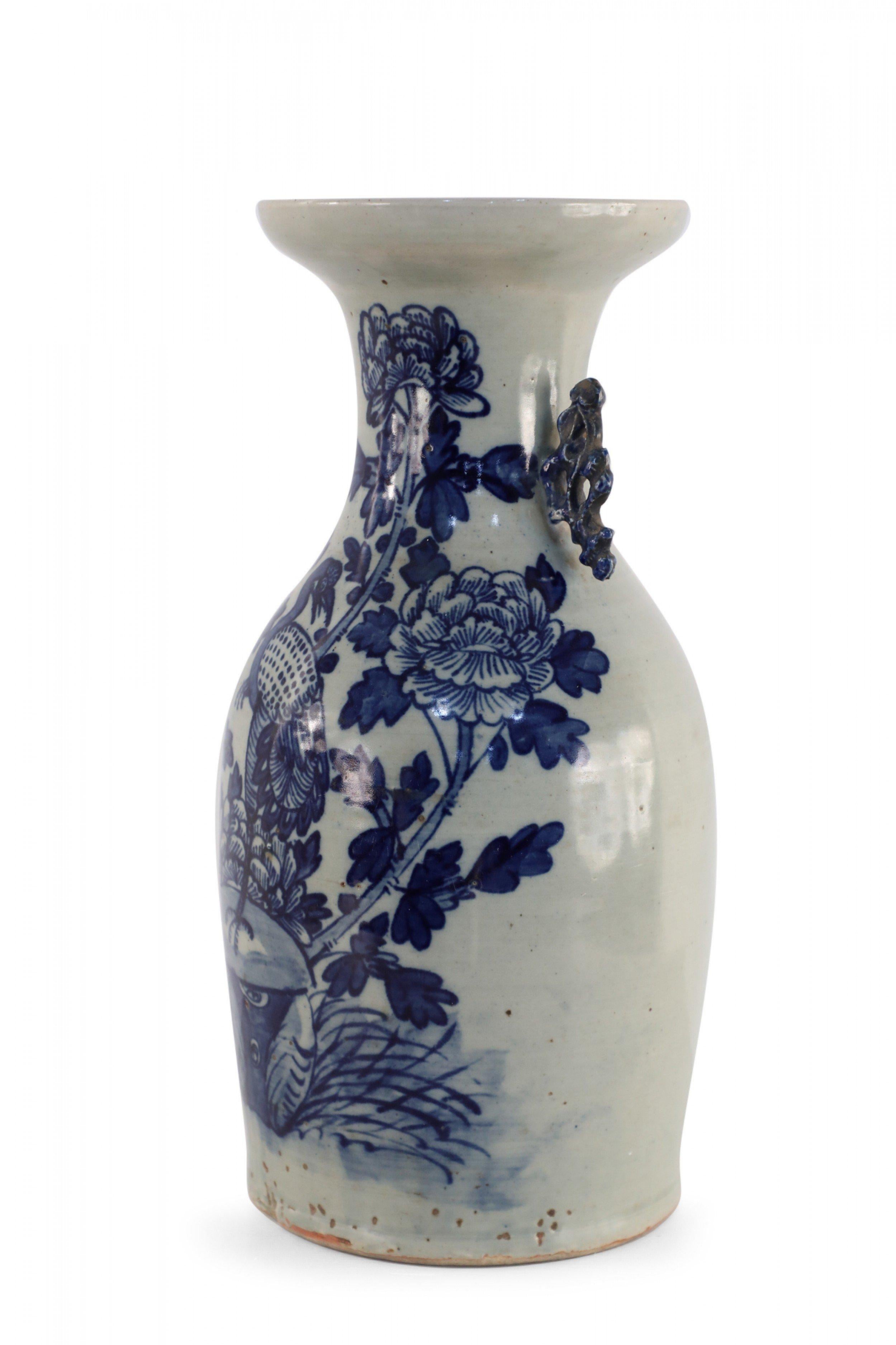Antique Chinese (Late 19th Century) white, porcelain urn with a navy egret amid florals and two blue scrolled handles along the neck.
  