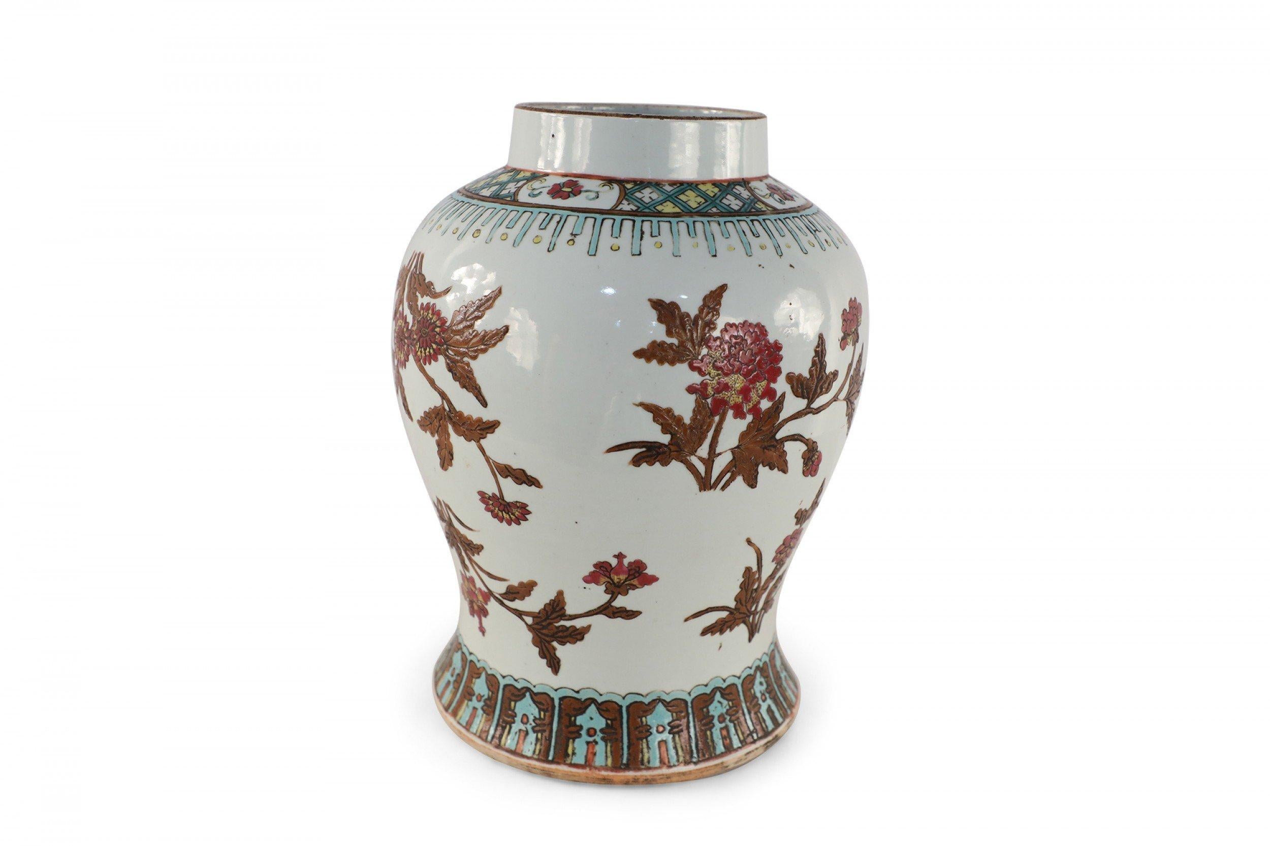 Chinese white porcelain vase decorated with an umber and pink floral motif wrapping the bulbous form, accented in blue and yellow patterned bands around the top and base.
      