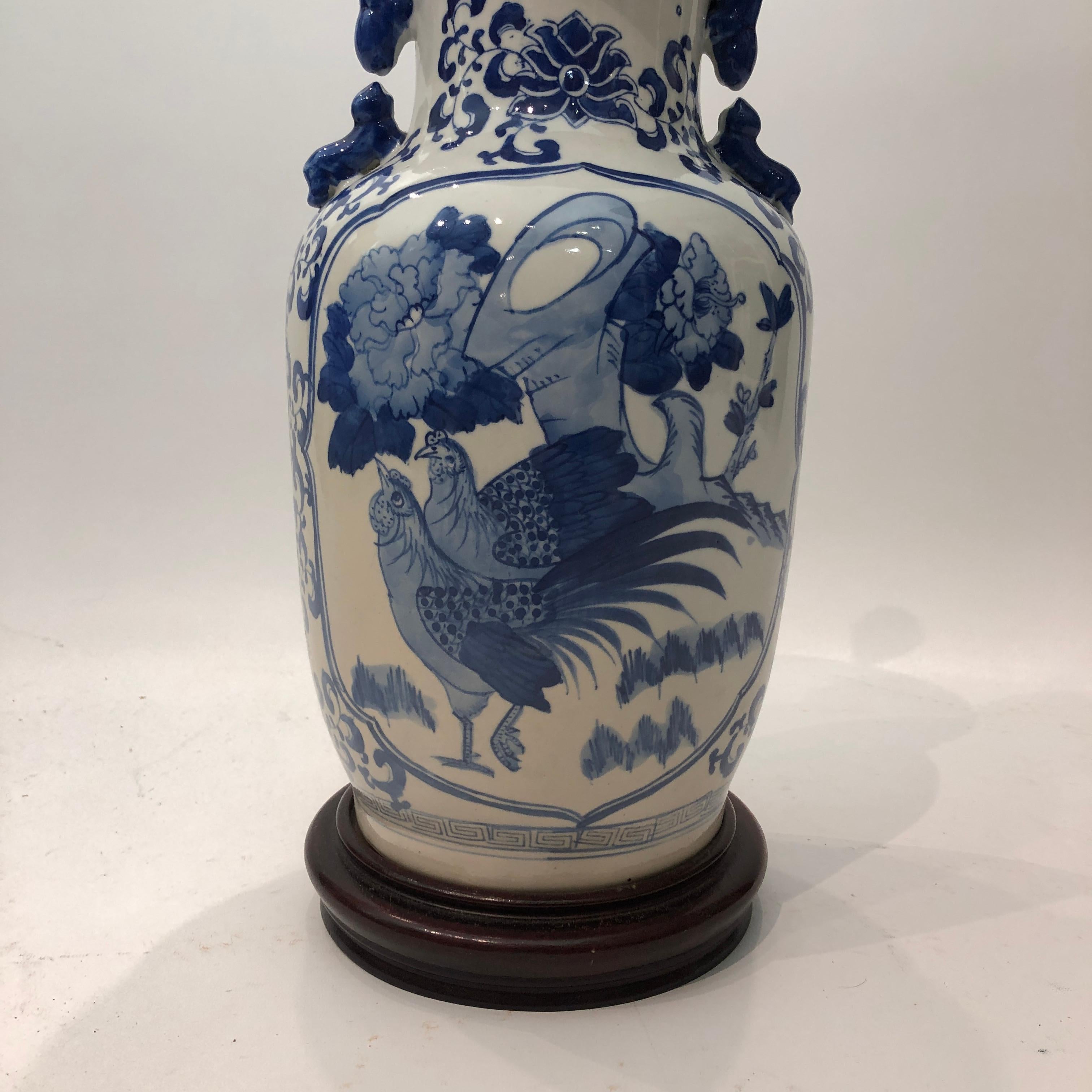 A classic Chinese table lamp in white and blue glaze with bird nature design. The ceramic base is hand decorated as vase and eventually top with a wood top and and base. Easy to place it in any room and play with lampshade designs depending on your