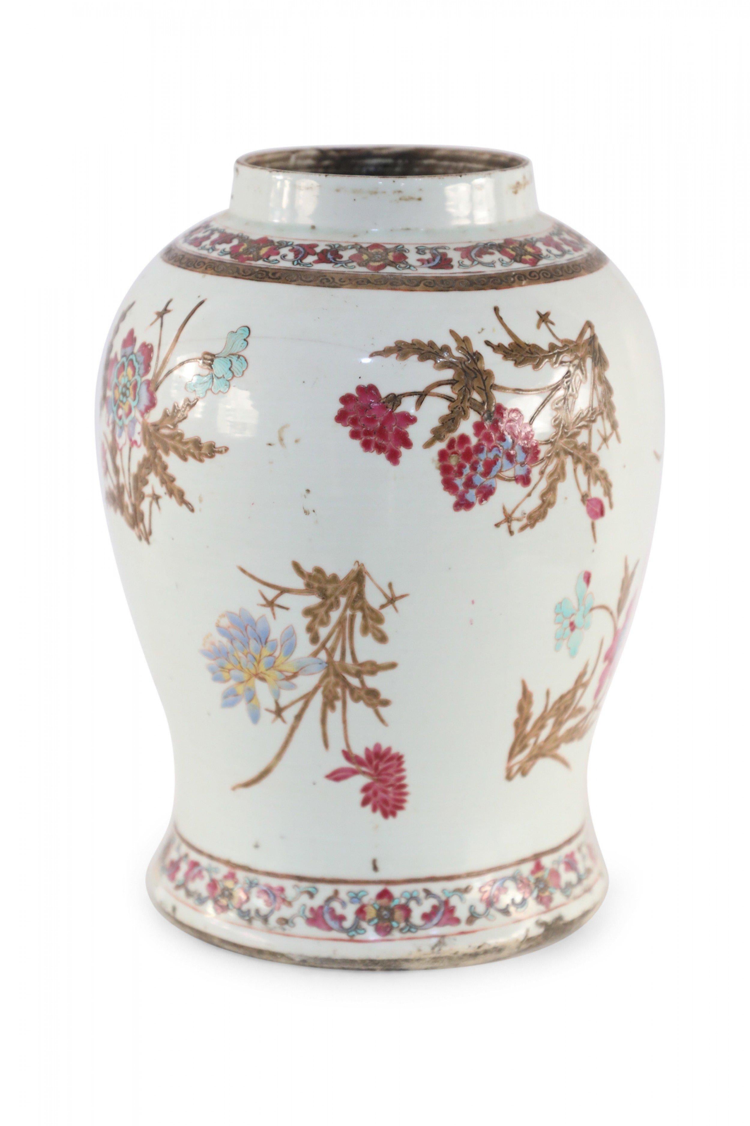 Chinese white porcelain vase decorated with incised and painted brown foliage and stems accented by magenta, light blue and yellow florals, and bands of floral garland at the opening and base.
    