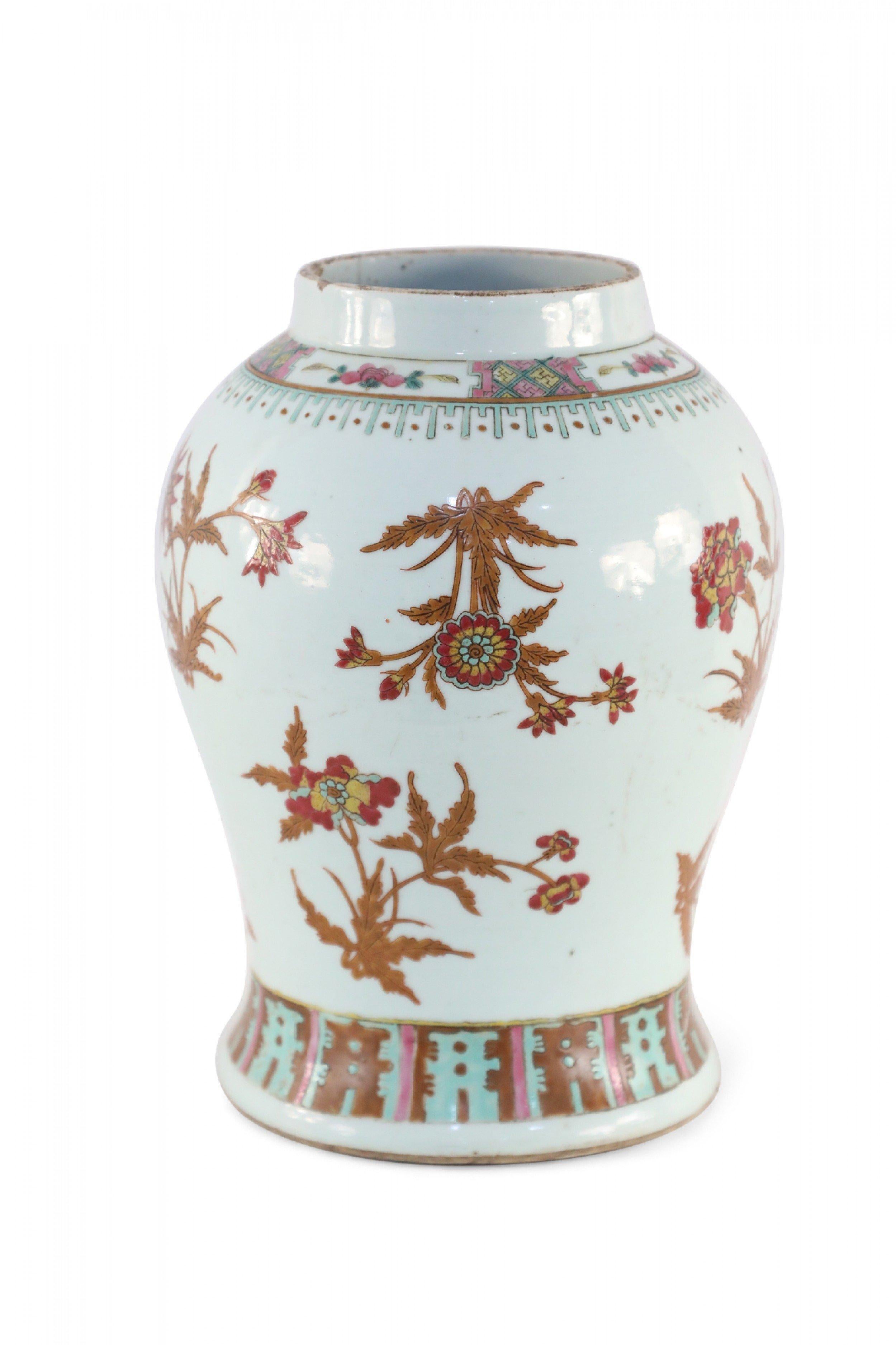 Chinese white porcelain vase decorated with incised and painted brown foliage and stems growing blooming red florals, and wrapped in geometric bands of blue, pink and yellow at the opening and base.
 