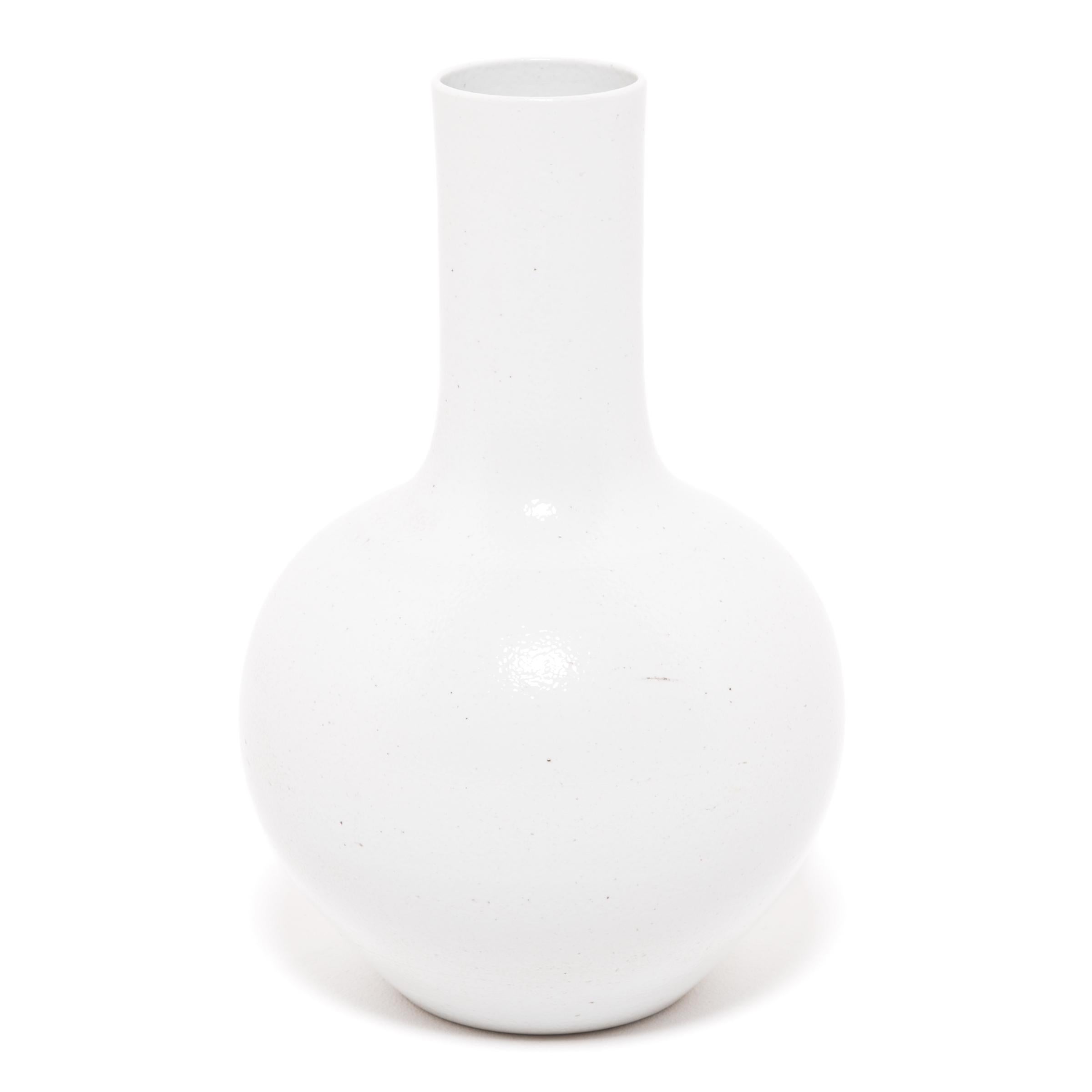 Drawing on a long Chinese tradition of ceramics, this striking long-necked vase is glazed in serene, cloud-inspired white. Sculpted by artisans in China's Zhejiang province, this contemporary vase reinterprets a traditional shape with clean lines