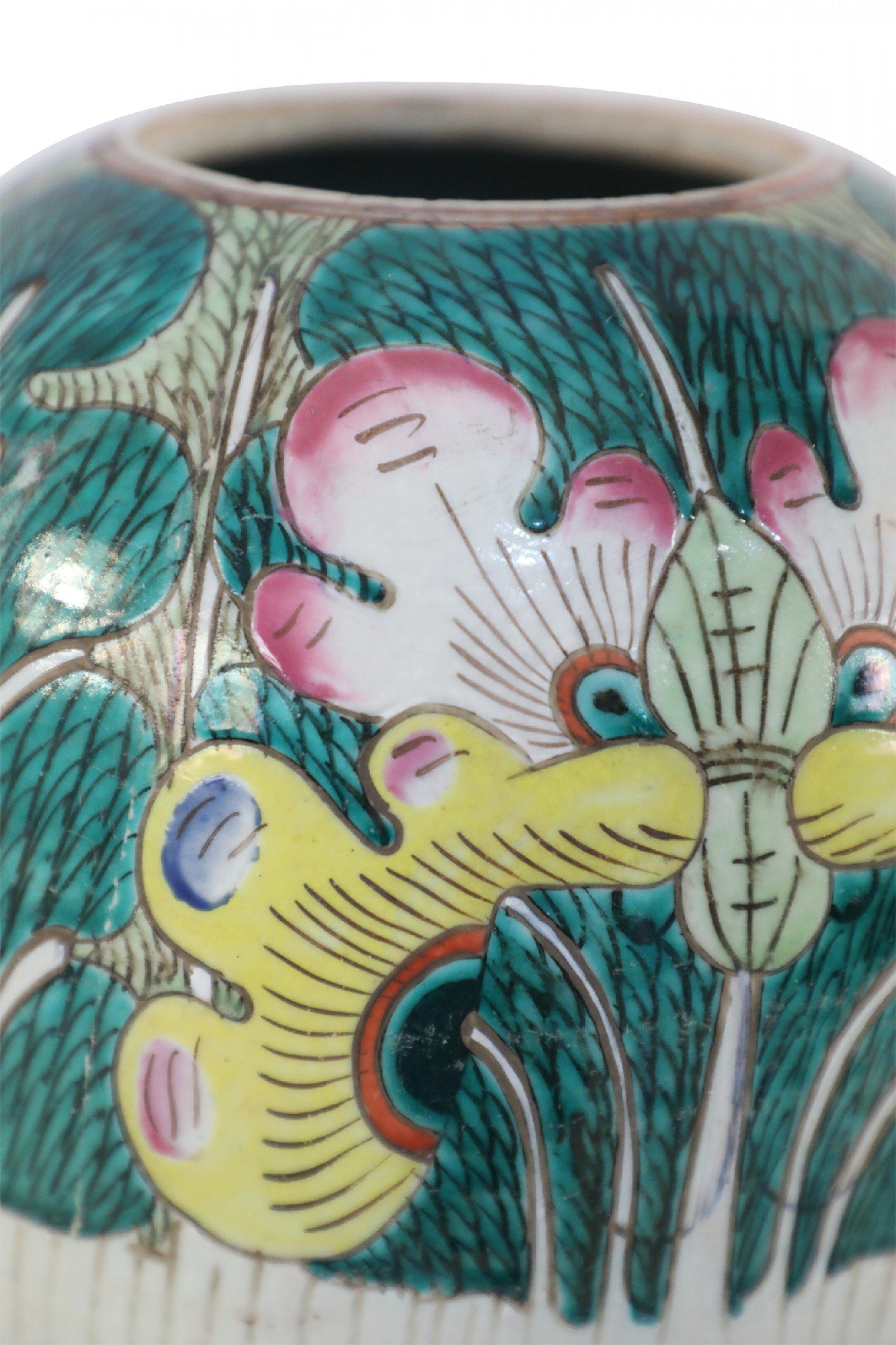 Antique Chinese (early 20th century) winter melon-form porcelain vase decorated with an incised, white bottom half that grows into verdant abstracted vegetal and peacock shapes on the top half in hues of green, pink and yellow. The base includes a