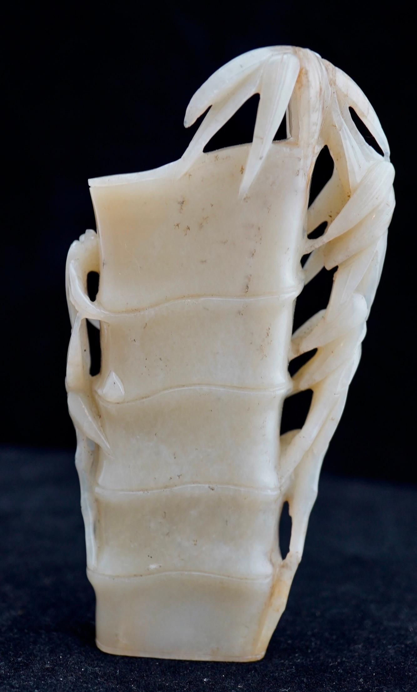 Chinese white jade carved vase in the form of the bamboo tree with leafs and trunk. Late 19th century.
