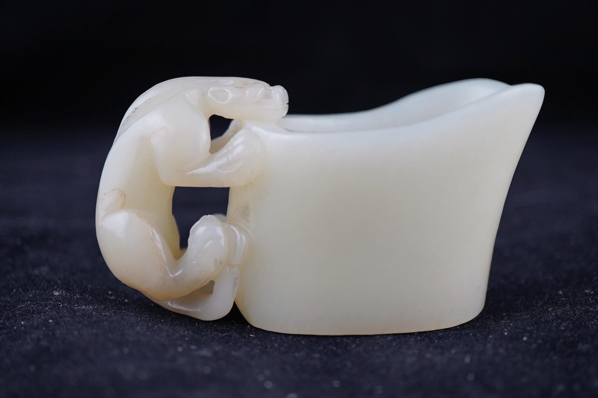Chinese white jade wine cup with chilong handle, 19th century. Fine detail and execution.