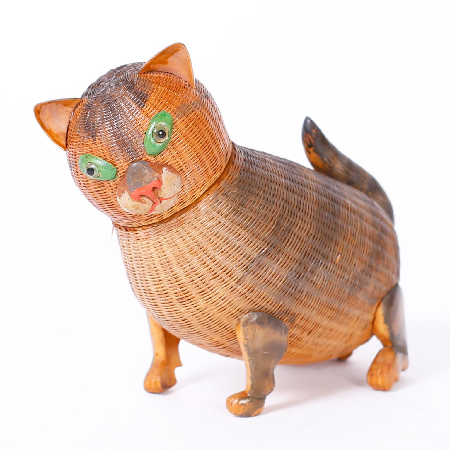 Delightful Chinese wicker kitten box from the noted Shanghai collection with a woven reed construction, carved wood legs, ears, nose and painted highlights. Removable head reveals hidden storage.