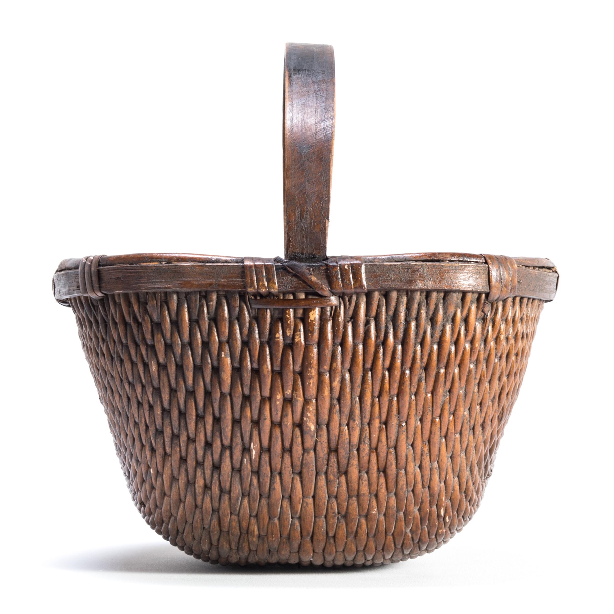 It is easy to imagine someone, long ago, walking to market on a beautiful summer day with this beautiful basket slung over their arm. Basket making is an ancient and humble craft, but in the hands of a truly skilled weaver willow branches, like