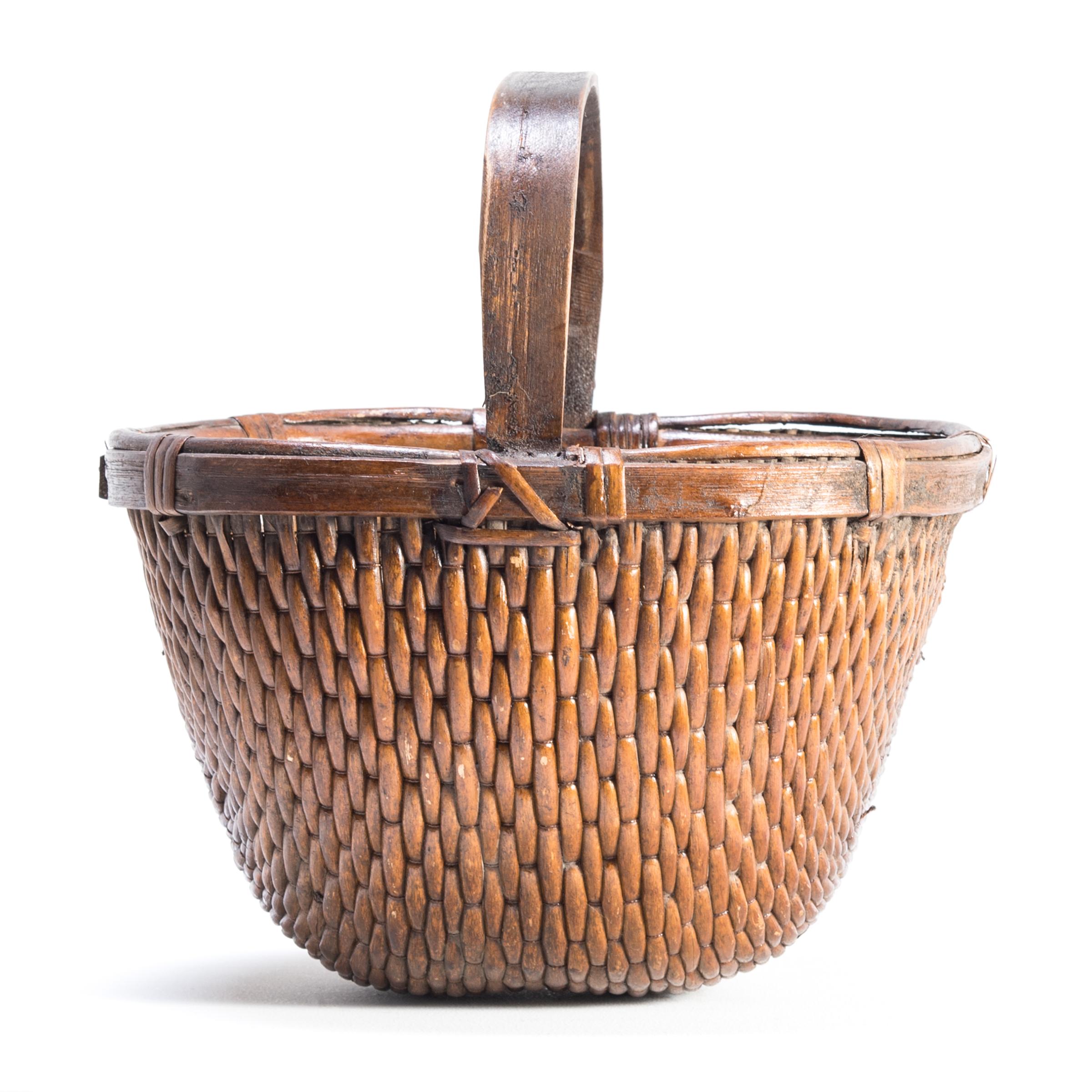 It is easy to imagine someone, long ago, walking to market on a beautiful summer day with this beautiful basket slung over their arm. Basket making is an ancient and humble craft, but in the hands of a truly skilled weaver willow branches, like