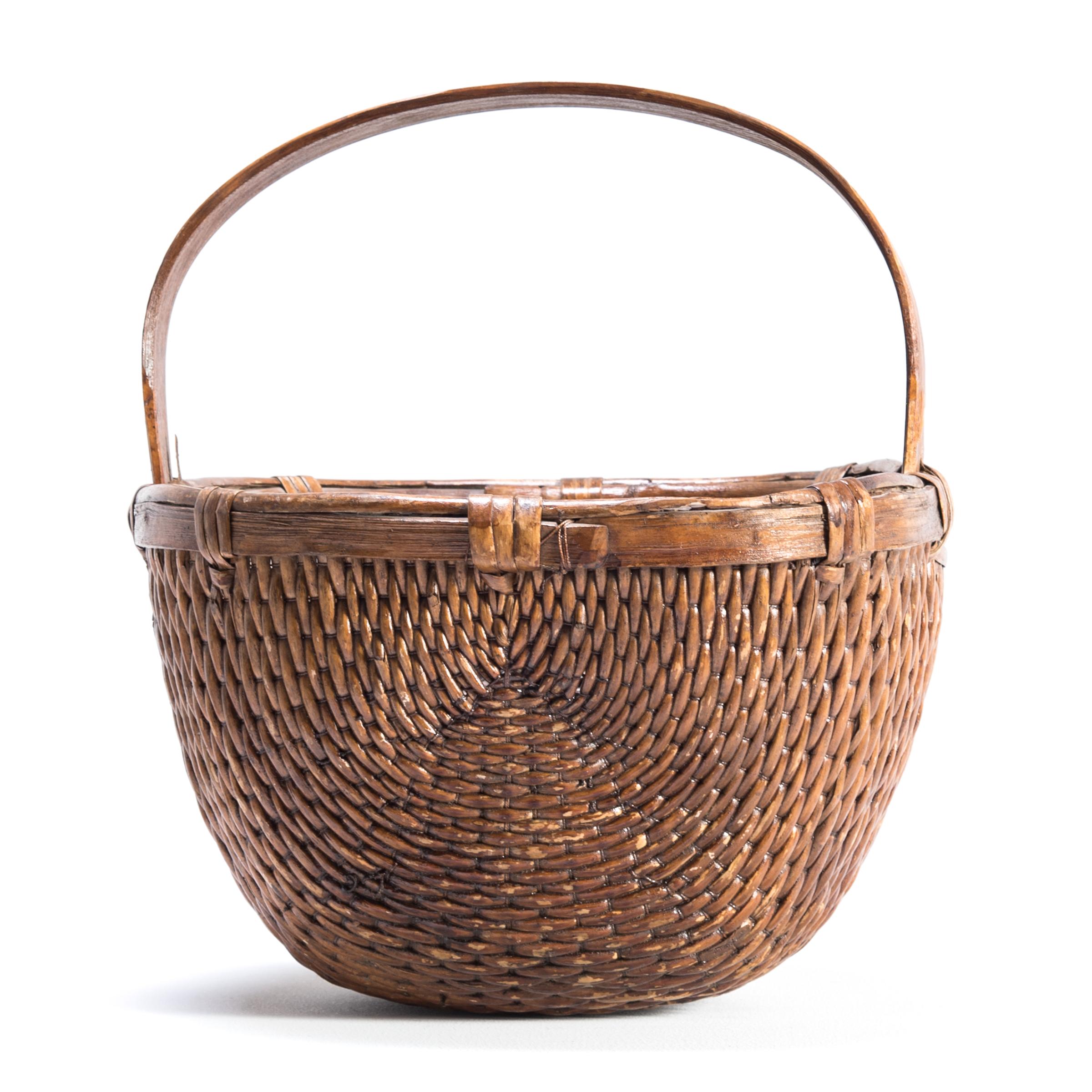 It is easy to imagine someone, long ago, walking to market on a beautiful summer day with this beautiful basket slung over their arm. Basket making is an ancient and humble craft, but in the hands of a truly skilled weaver willow branches, like