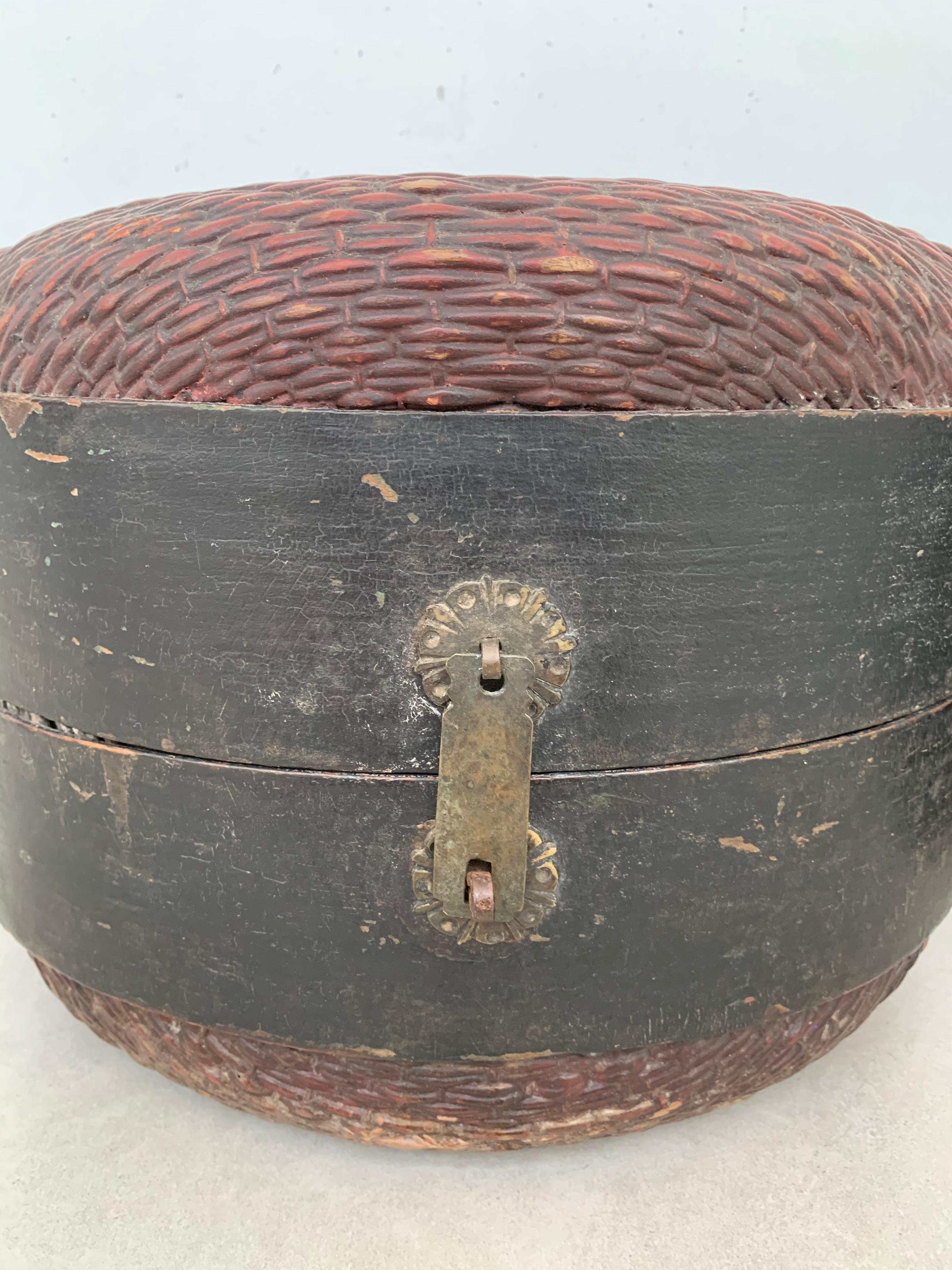 This pair of hat boxes from China feature curved wooden supports and the original metal fittings, They were hand-crafted using willow reads and have a weathered and age related patina. 

Dimensions: Height 23cm x Diameter 32cm & Height 25cm x