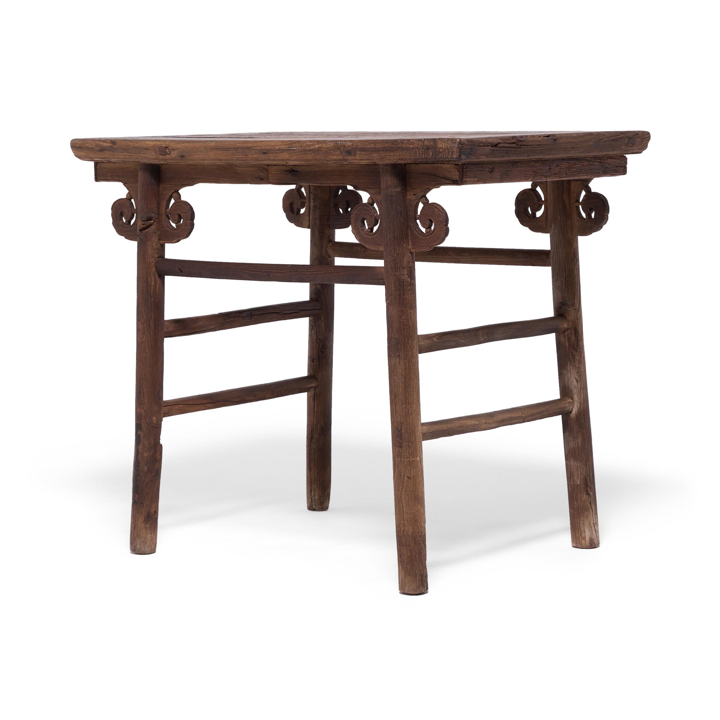 Ideal as a console or center table in the modern home, this exquisite 18th-century wine table charms with rounded legs, simple double stretchers, and decorative cloud-form spandrels. A fixture of China's time-honored history of wine making, the