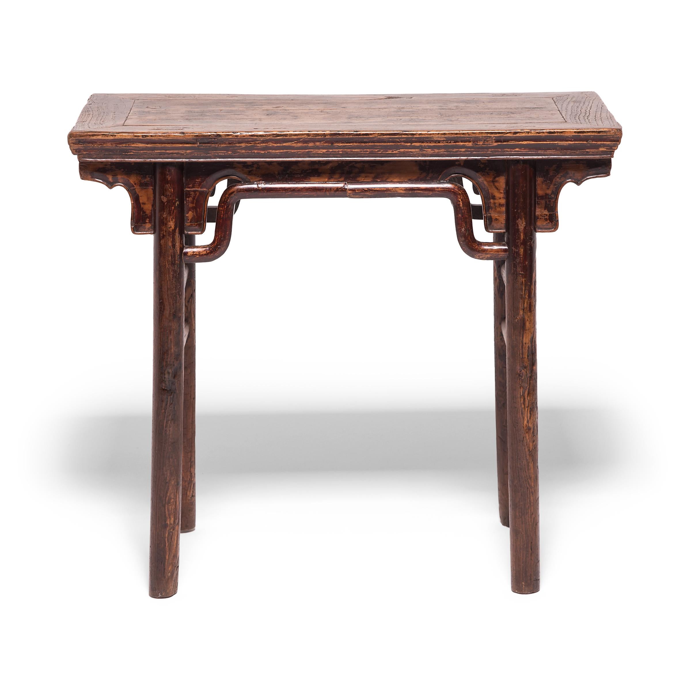 The elegant design of this 19th century table is inspired by earlier Ming dynasty furniture designs highly prized by collectors. Clean lines, simple humpback stretchers, and a beautifully worn patina only add to the console table's value. The