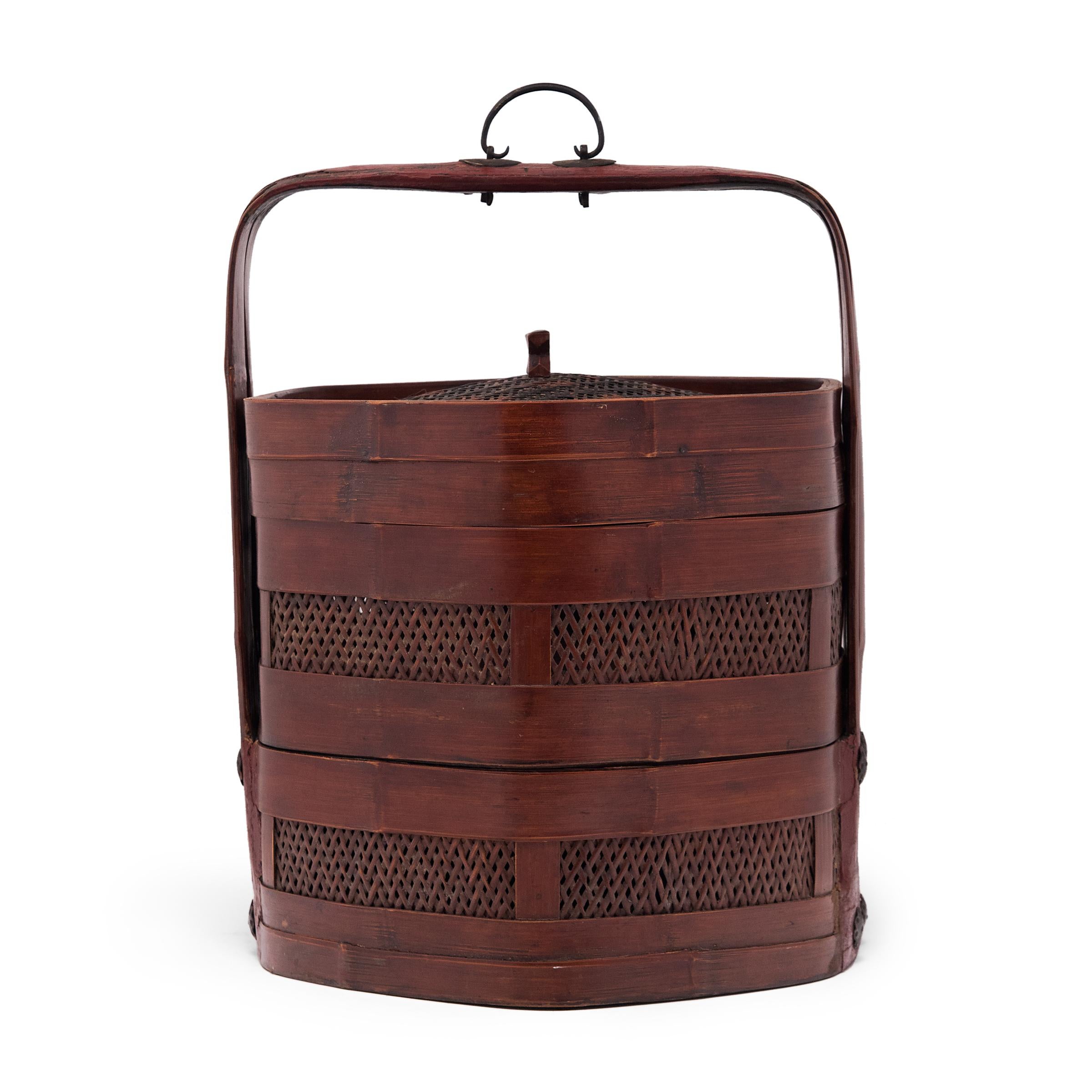 The basic form of this three-tiered Chinese box has remained unchanged for a thousand years. Used like a modern lunchbox, each tier of this portable stacking box would have been filled with food and carried around by the handle. This example dates