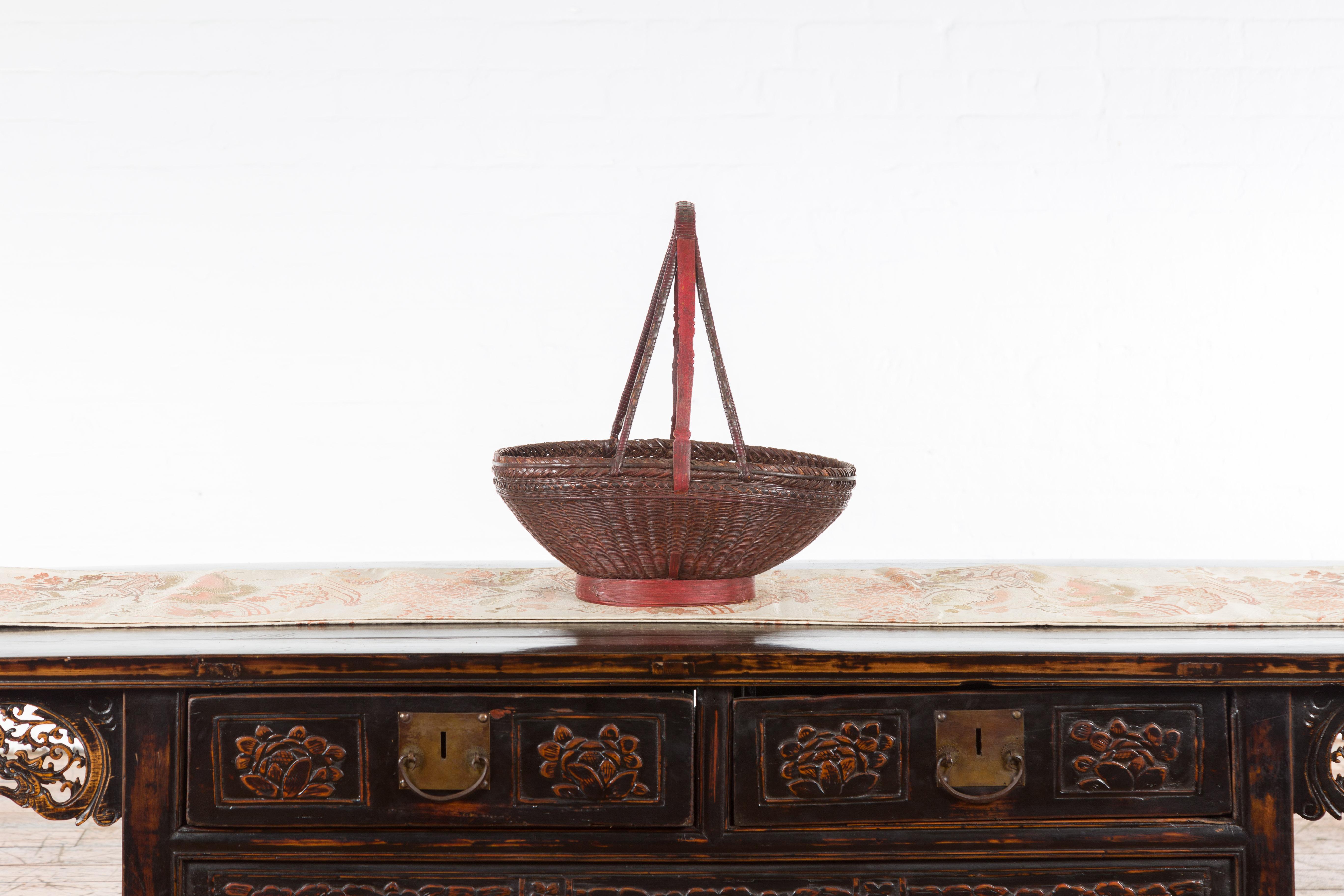 20th Century Handwoven Chinese Red & Brown Rattan Market Basket with Tall Carrying Handle For Sale