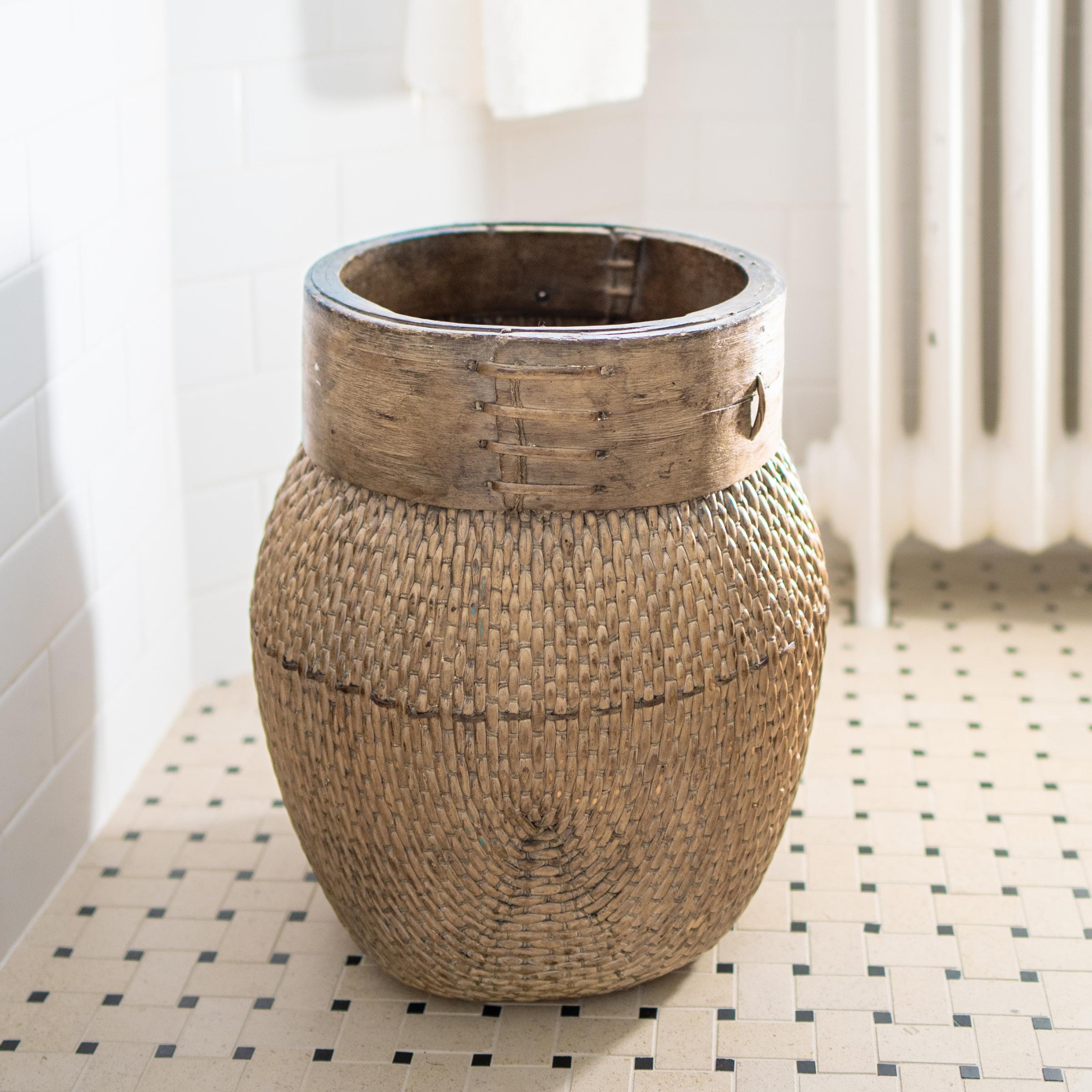 Centuries ago, a woven reed fisherman’s basket such as this would have been common in rural China as an everyday item, used until it became worn through. This hand-woven example remains in beautiful condition and features a tapered woven body