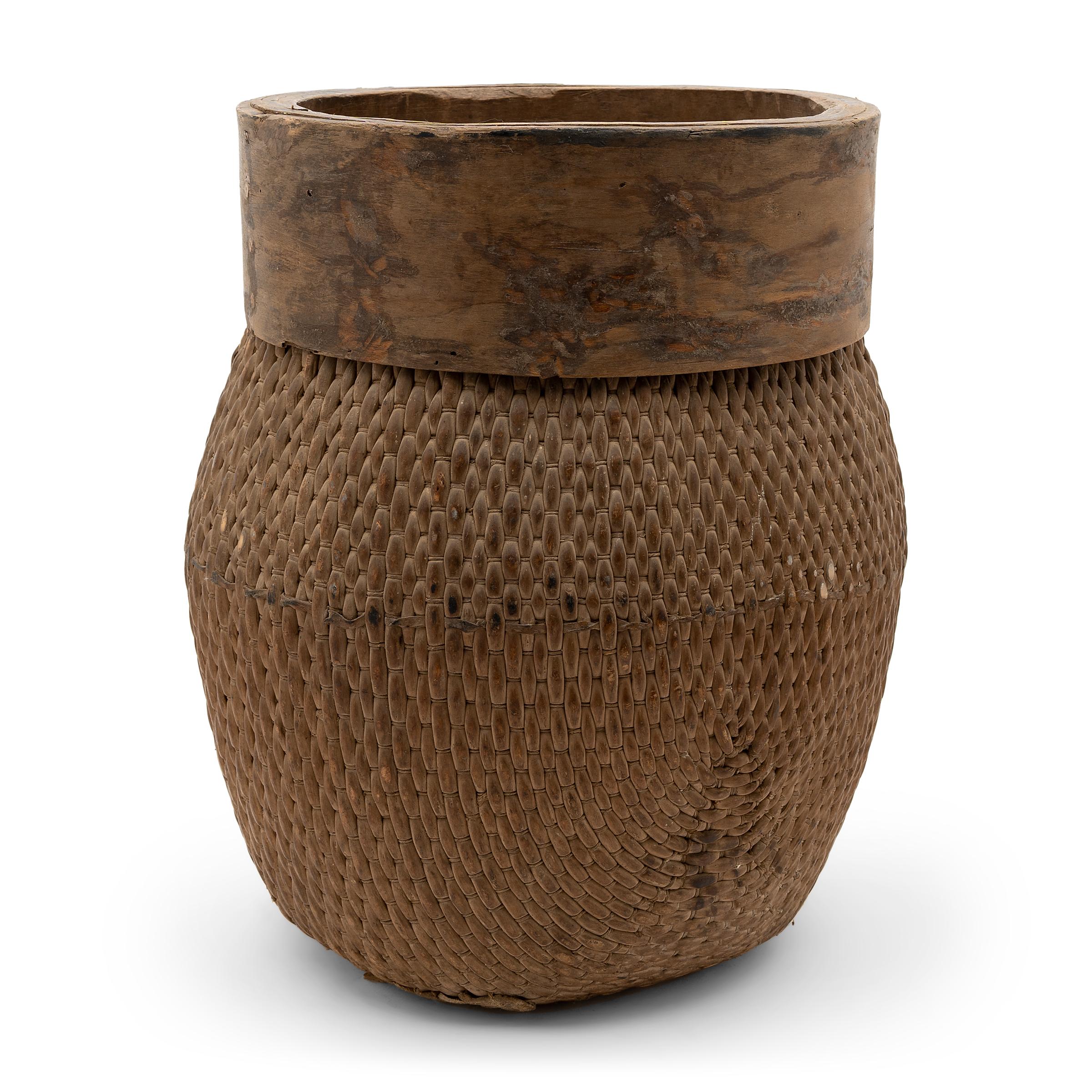 Centuries ago, a woven reed fisherman’s basket such as this would have been common in rural China as an everyday item, used until it became worn through. This particular example remains in beautiful condition, and exists today as a lovely