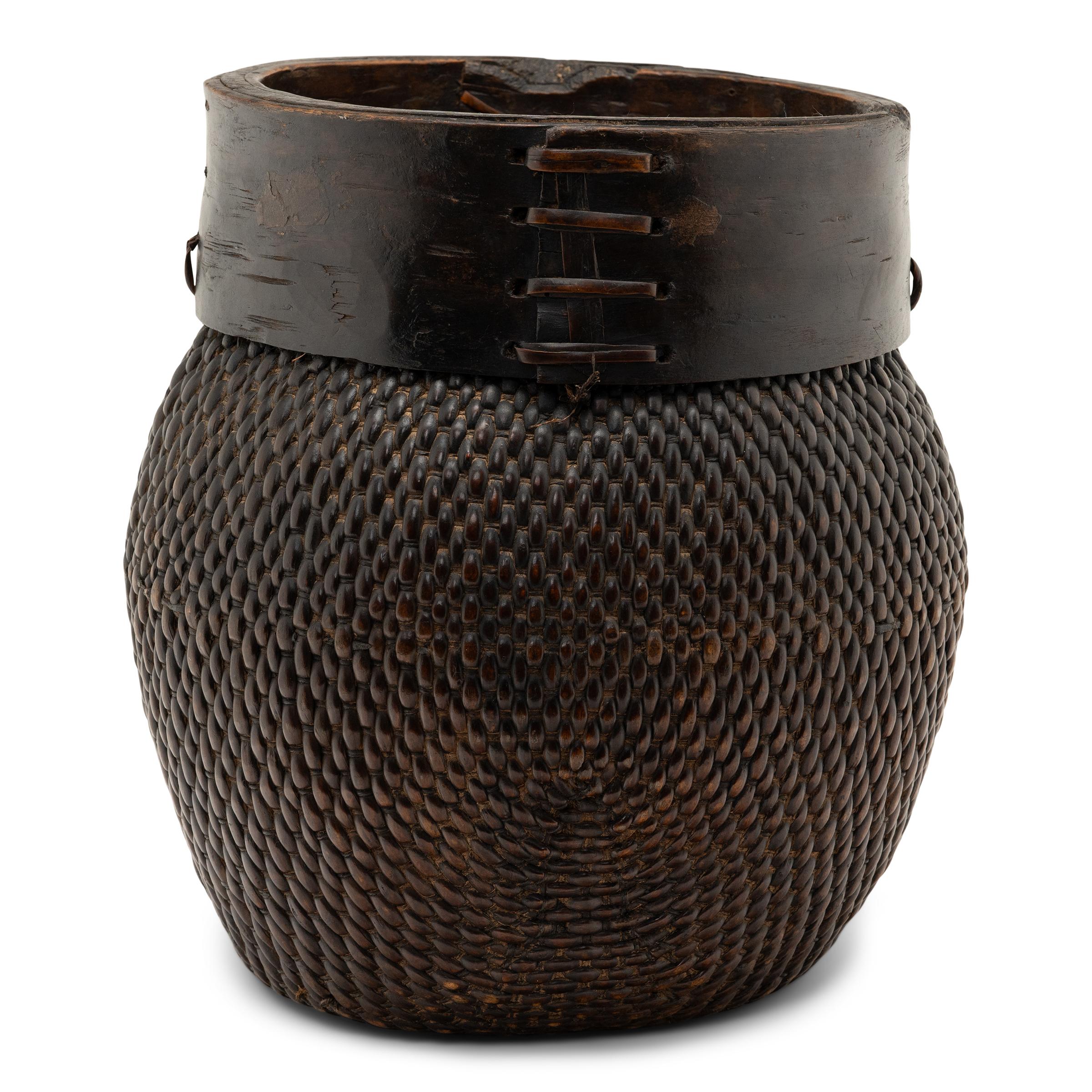 Centuries ago, a woven reed fisherman’s basket such as this would have been common in rural China as an everyday item, used until it became worn through. This particular example remains in beautiful condition, and exists today as a lovely