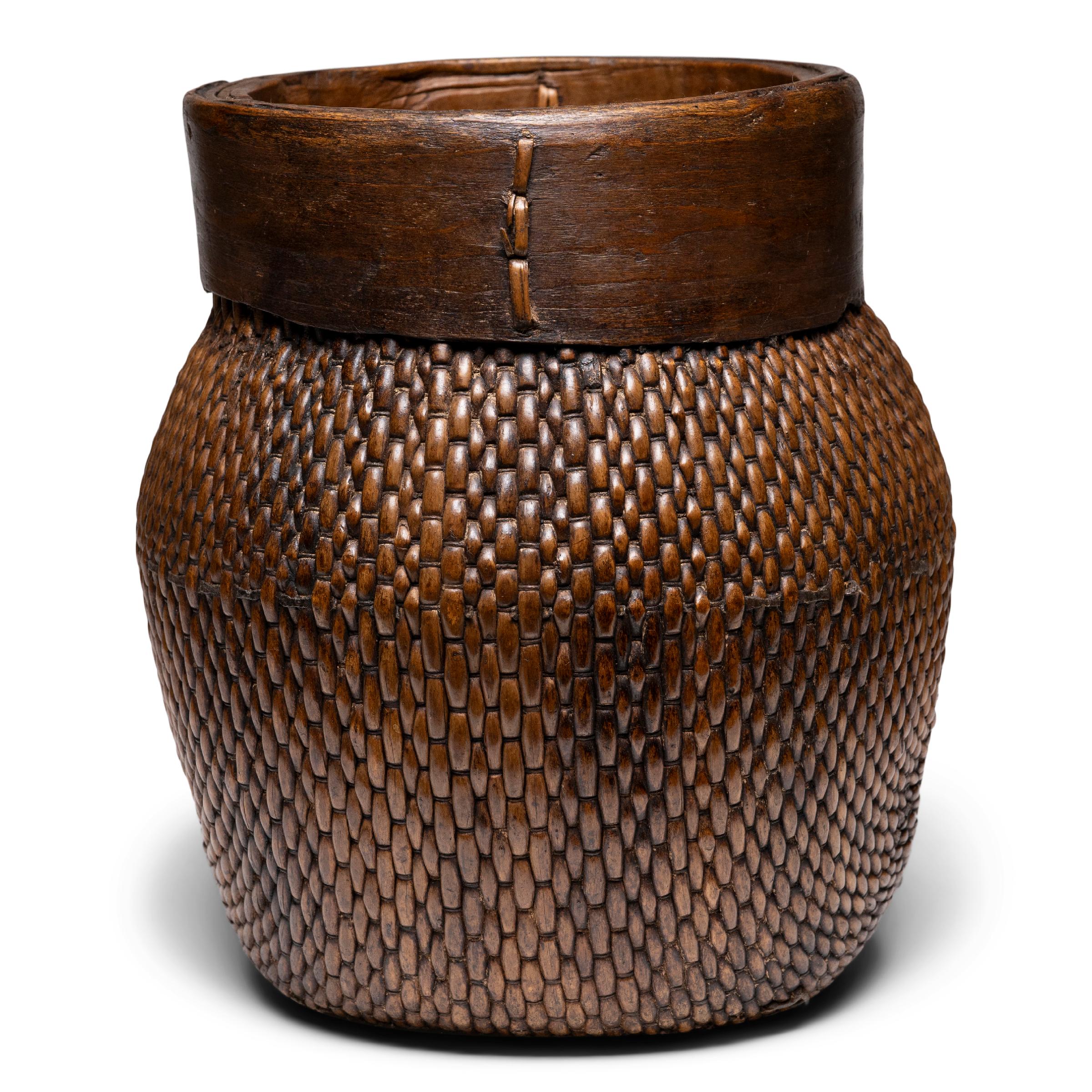 Centuries ago, a woven reed fisherman’s basket such as this would have been common in rural China as an everyday item, used until it became worn through. This hand-woven example remains in beautiful condition and features a tapered woven body