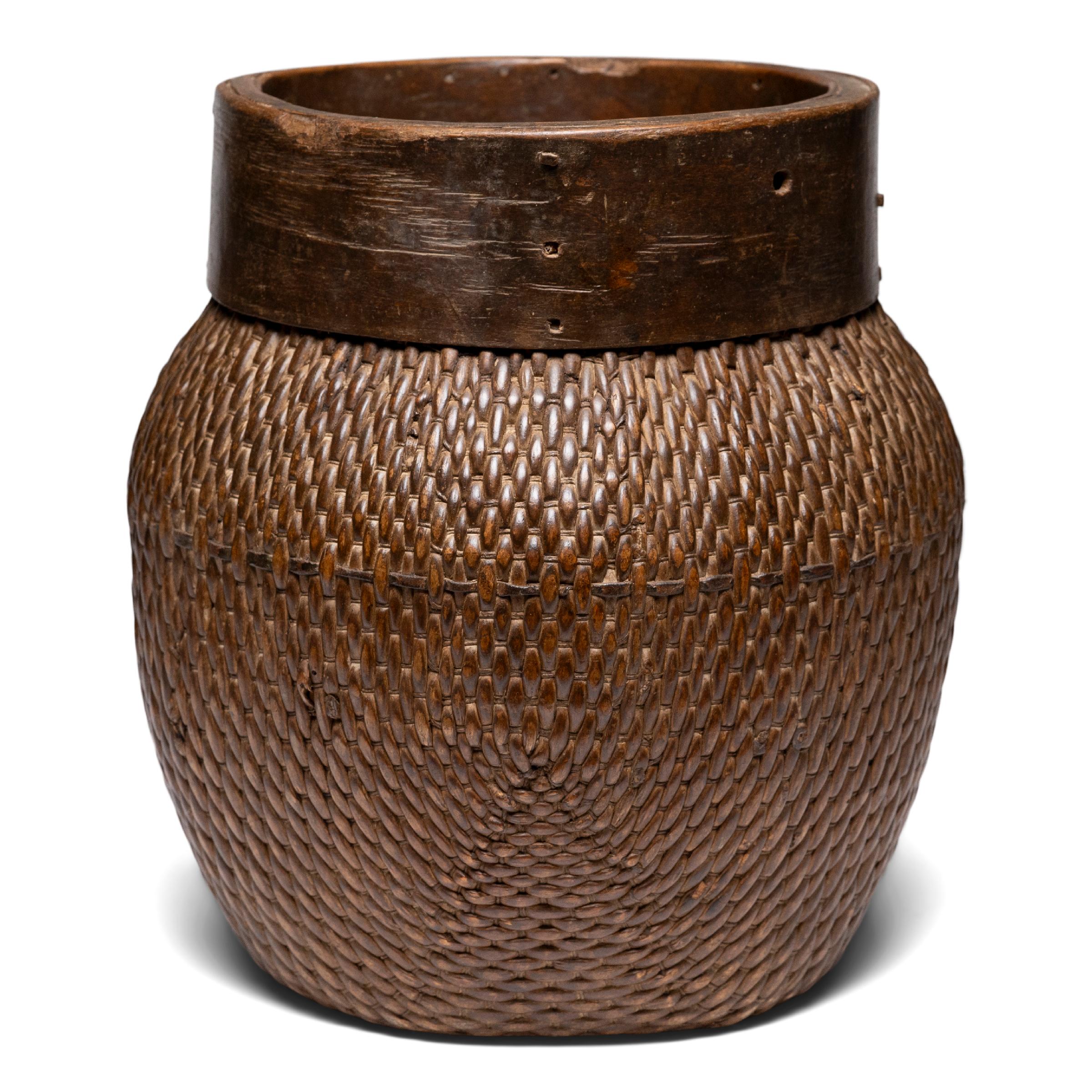 Centuries ago, a woven reed fisherman’s basket such as this would have been common in rural China as an everyday item, used until it became worn through. This hand-woven example remains in beautiful condition and features a tapered woven body