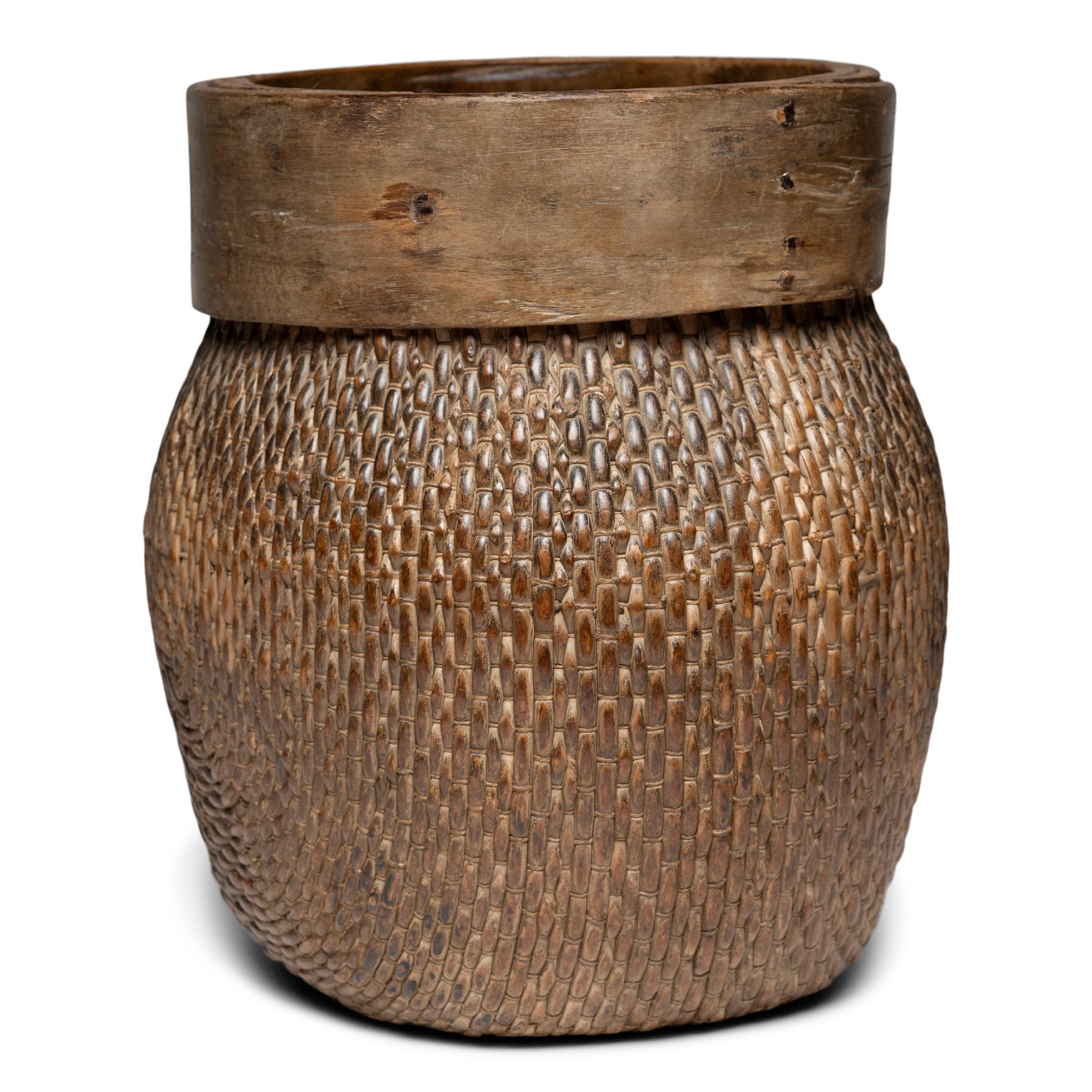 Centuries ago, a woven reed fisherman’s basket such as this would have been common in rural China as an everyday item, used until it became worn through. This hand-woven example remains in beautiful condition and features a tapered woven body