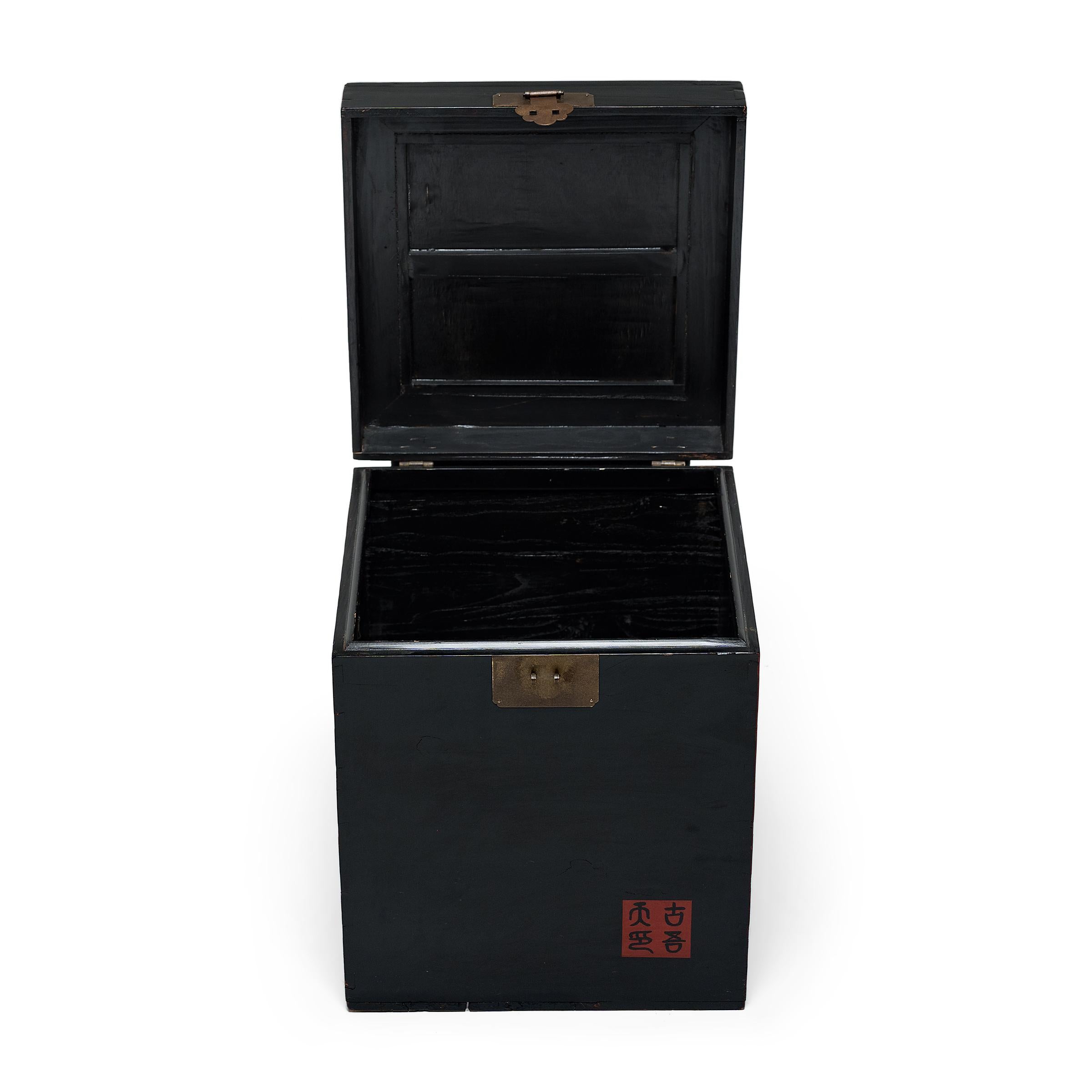 Crafted in the style of Chinese furniture, this petite storage chest is the perfect place to stow cords, toys, blankets, or anything you want stored beautifully. The square trunk features a glossy, black lacquer finish and a woven lidded top