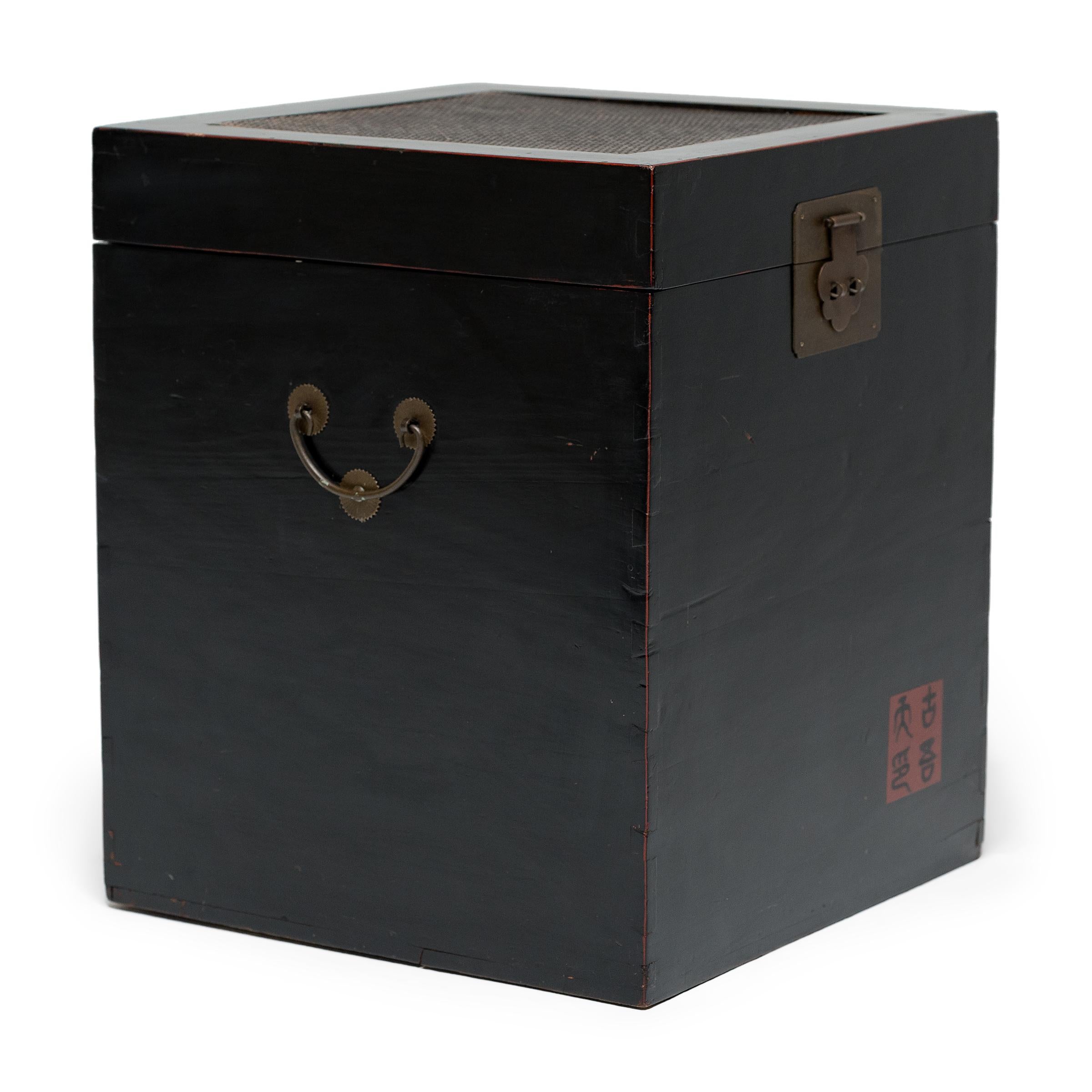 Crafted in the style of Chinese furniture, this petite storage chest is the perfect place to stow cords, toys, blankets, or anything you want stored beautifully. The square trunk features a glossy, black lacquer finish and a woven lidded top
