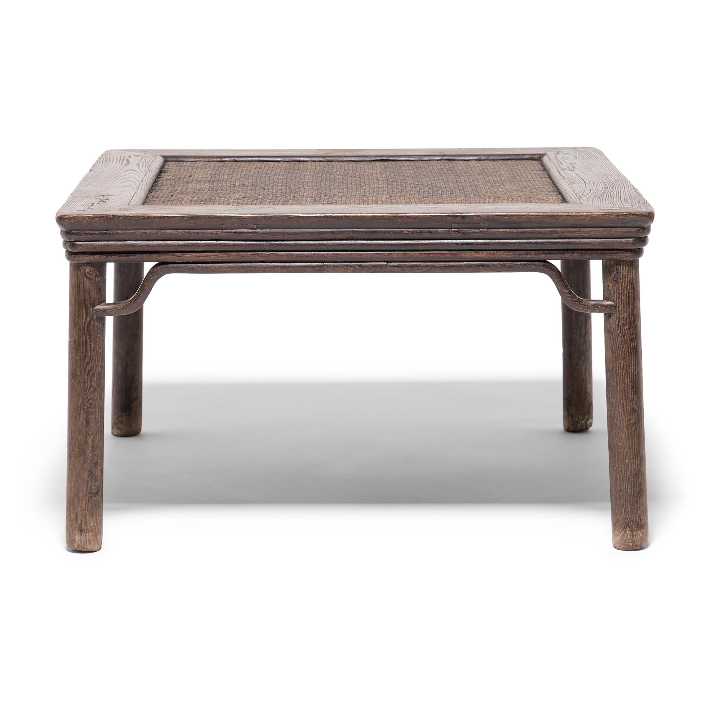 Curving spandrels, a stepped apron and subtly splayed legs epitomize the simple grace of this 19th century square stool, known as a feng deng. Handcrafted from Chinese elmwood, this object projects a proud, knowing stance and carries a wealth of