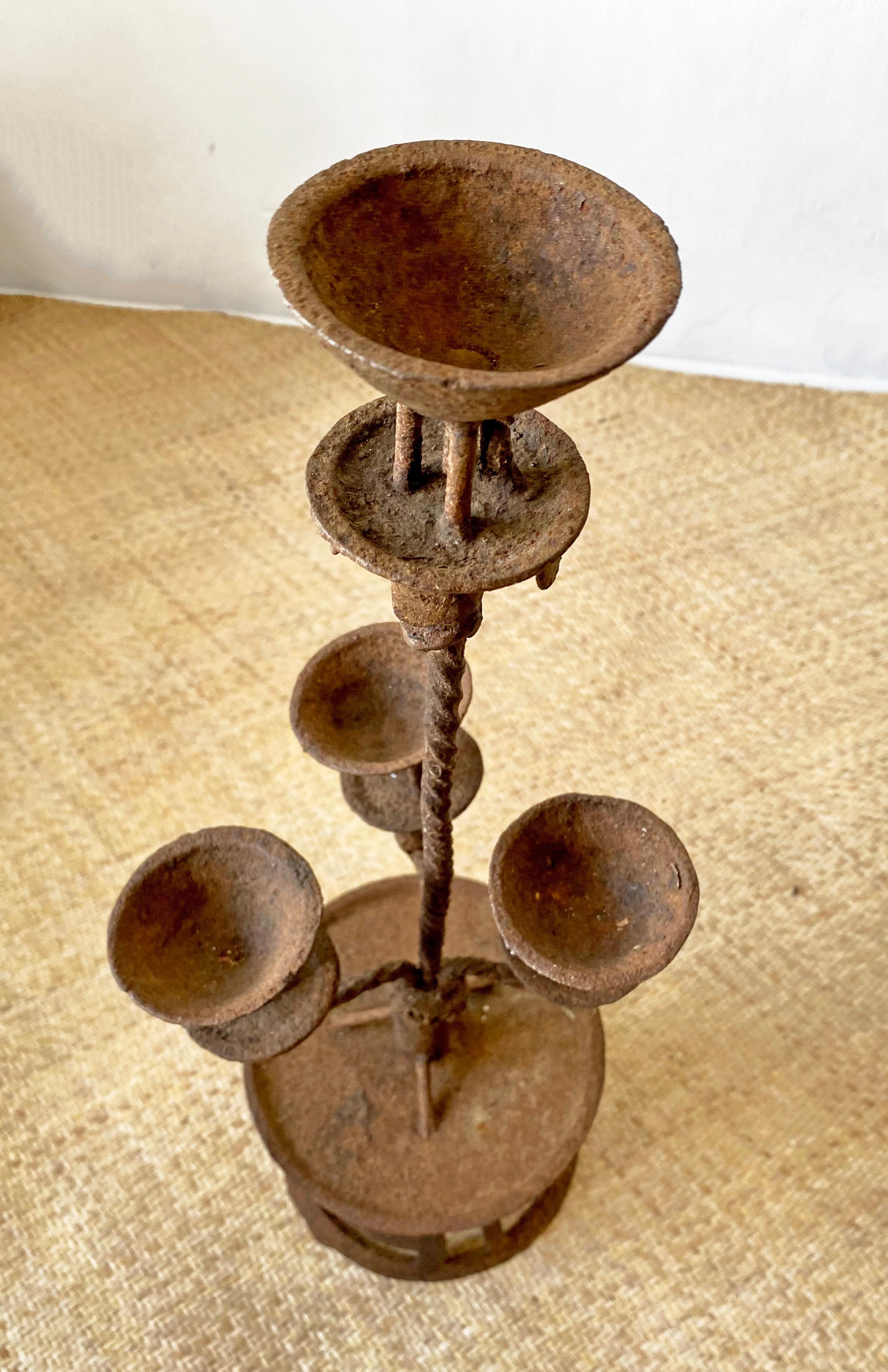 A stunning pair of early 20th century wrought iron candleholders from China with a spiral stem design and aged related patina. 

Dimensions: Height 54cm x diameter 18cm.