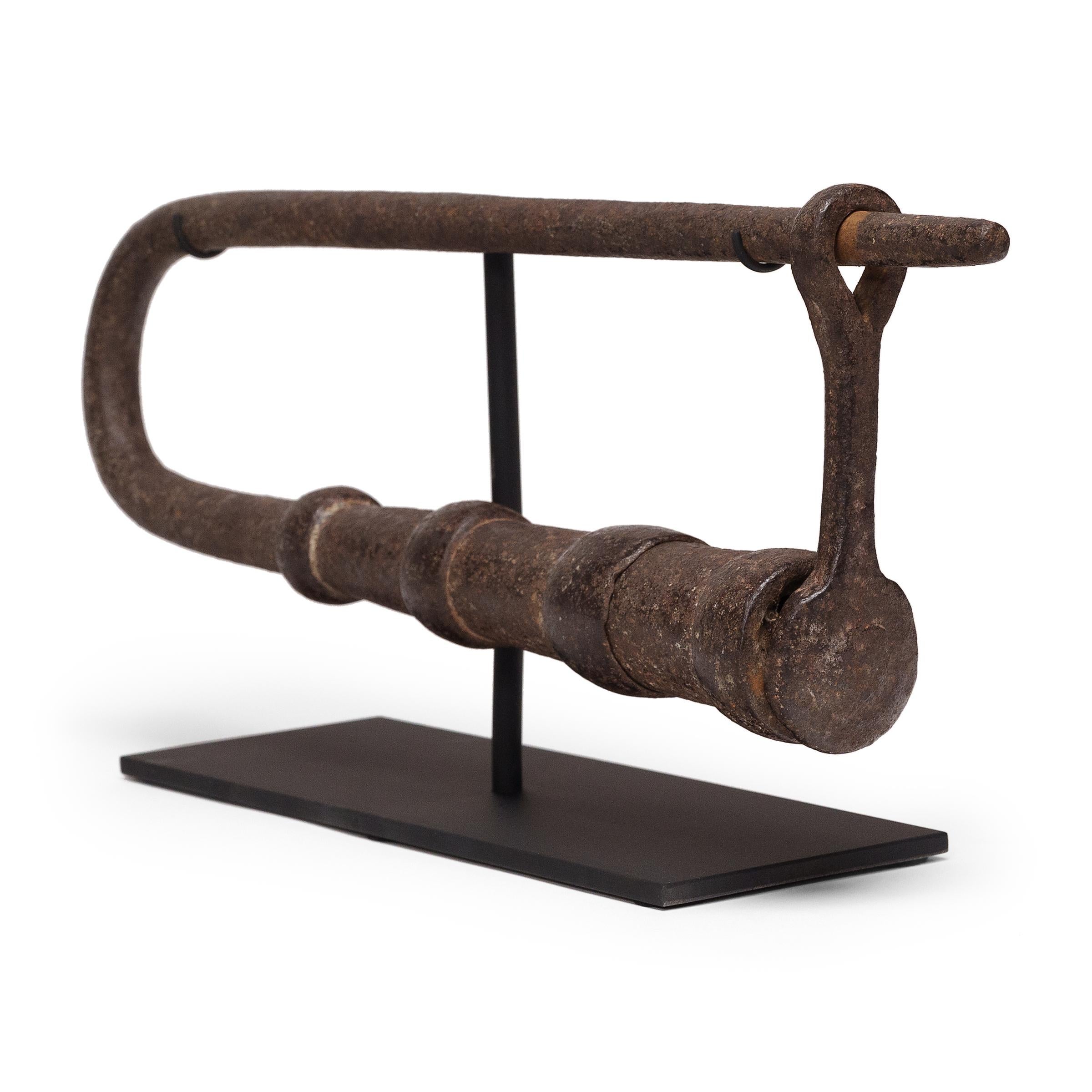 An impressive antique padlock of wrought iron, originally used to secure large doors such as those used at a temple entrance or courtyard gate. Set on a custom steel mount, the iron lock lives on as a unique tabletop sculpture with minimal form and