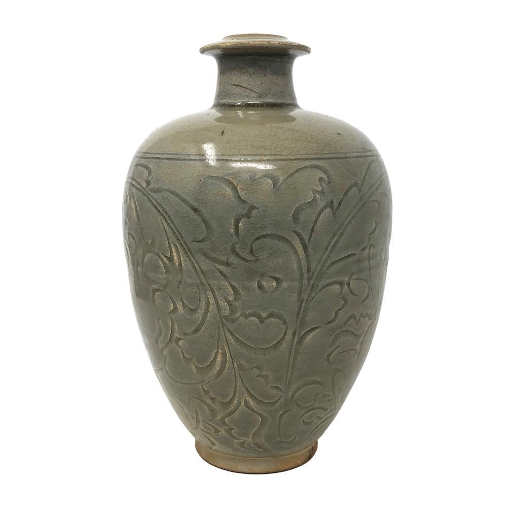 Chinese Yaozhou Celadon Ceramic Bottle Vase, Northern Song, Shaanxi Province. A high fired bottle form with narrowed base, bulbous body, high shoulder, narrow neck and flared flange mouth. The body with carved design of free spirited, deep and