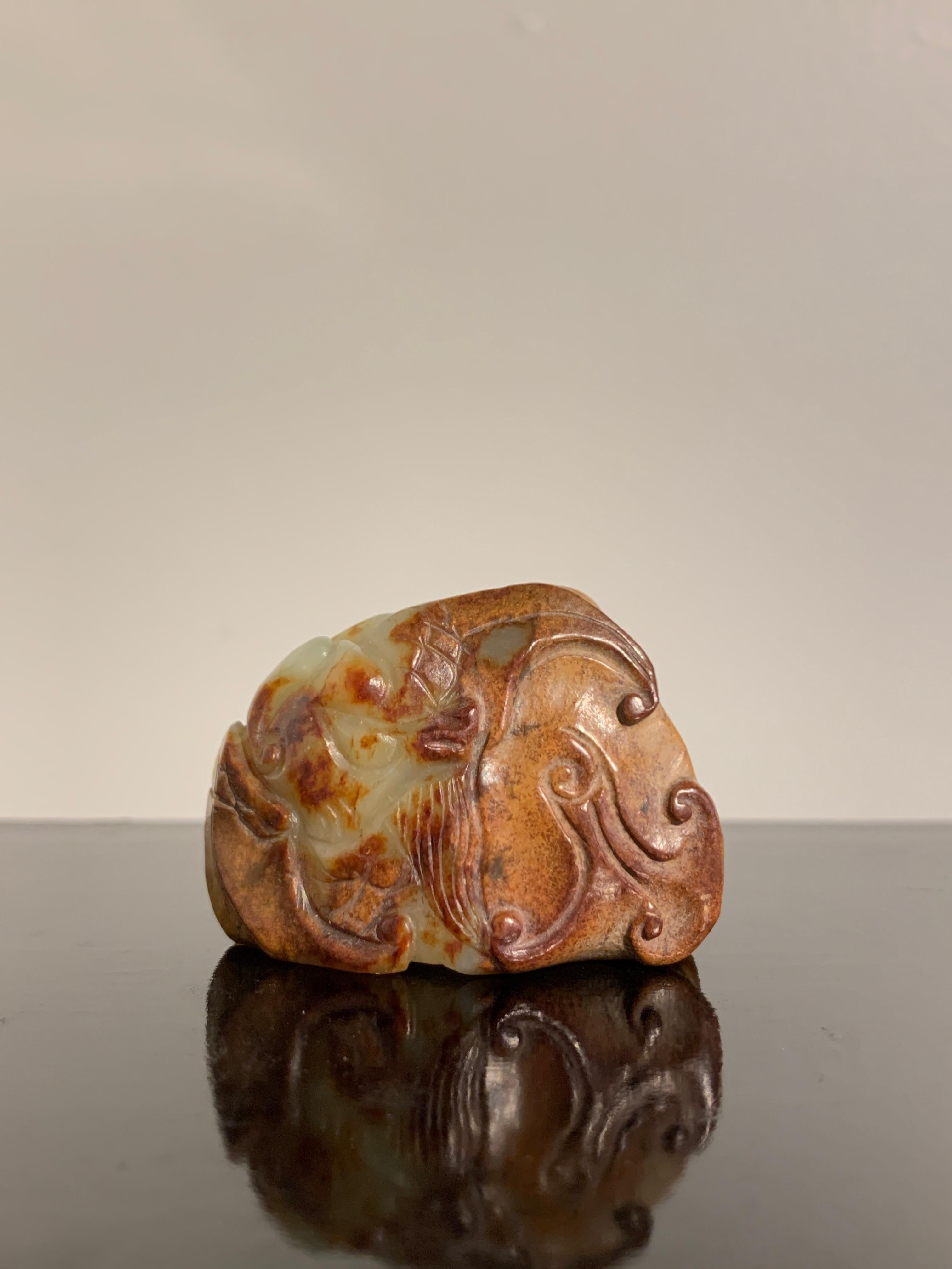 A superb Chinese yellow and russet nephrite jade carving of a mythical beast, Ming Dynasty (1368 to 1644) or earlier, China

The mythical beast is portrayed with feline features, including a muscular, compact body, a broad face with flattened