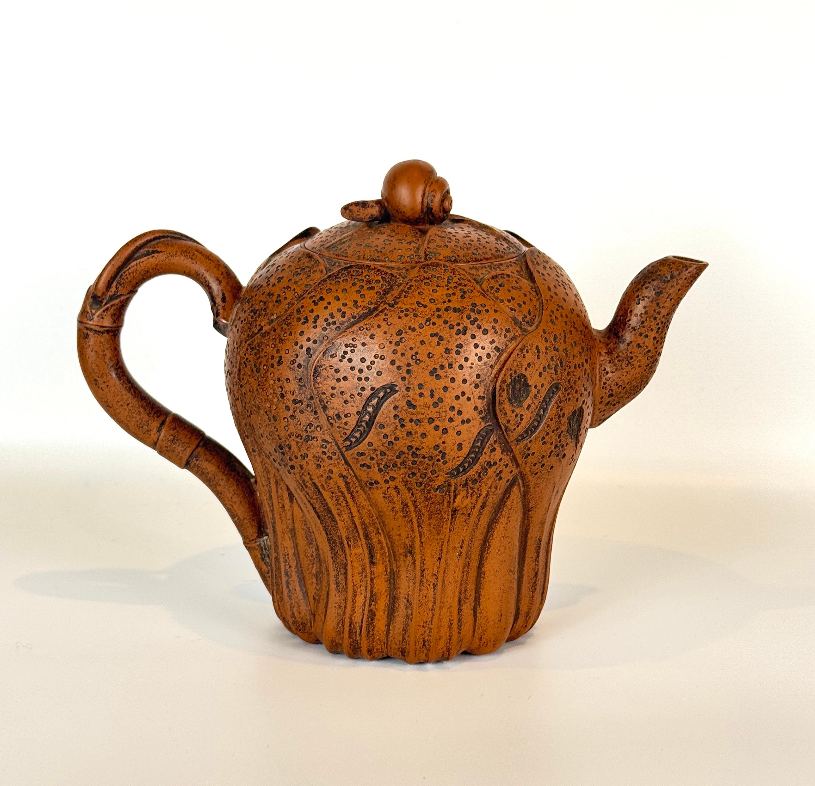 Chinese Yixing Clay  or Zisha Clay Teapot, probably 20th Century. This charming decorative teapot is formed of Yixing Clay with a wonderful warm color, the body shaped in the form of overlapping Bok Choy leaves with a bamboo form handle, the top